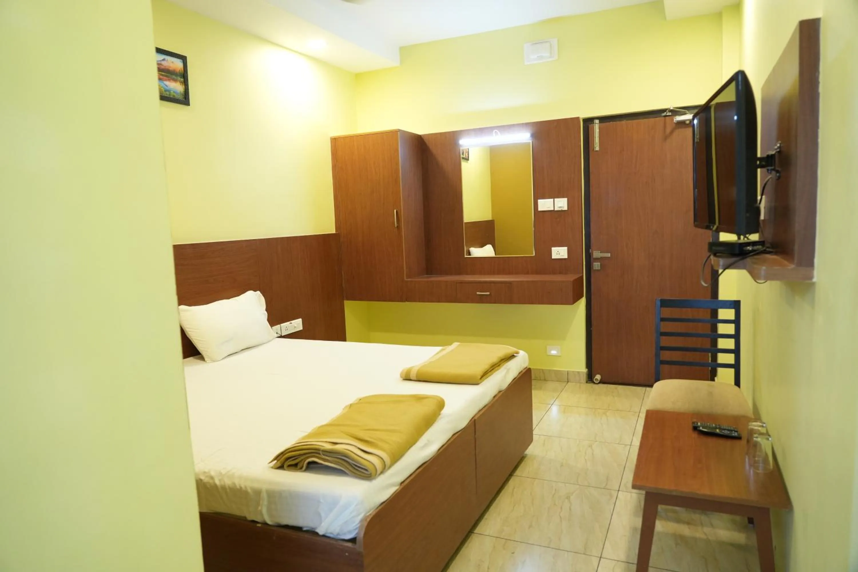 Photo of the whole room, Bed in Sri Krishnan Residency