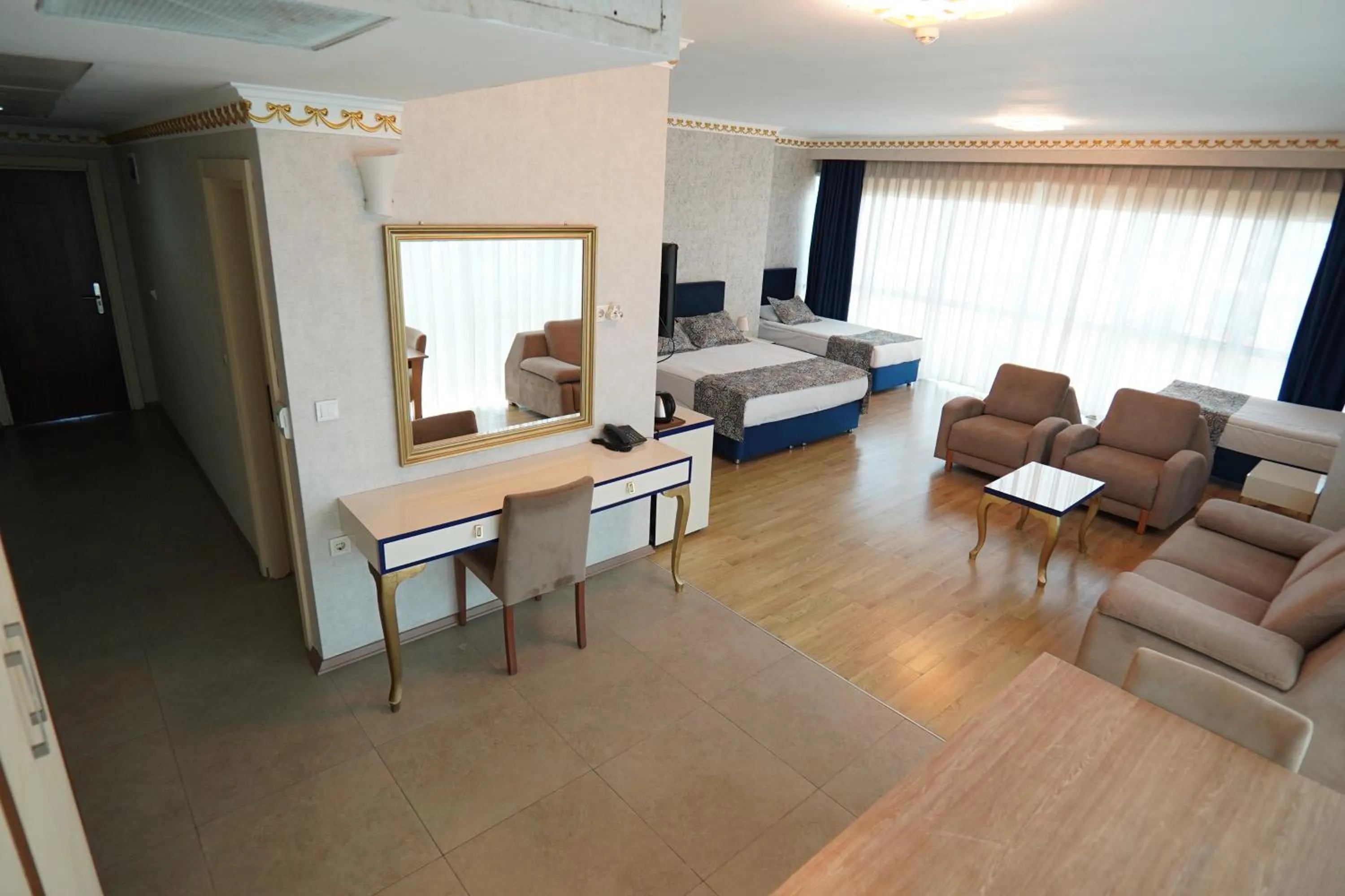 Communal lounge/ TV room, Bed in Grand Karot Hotel