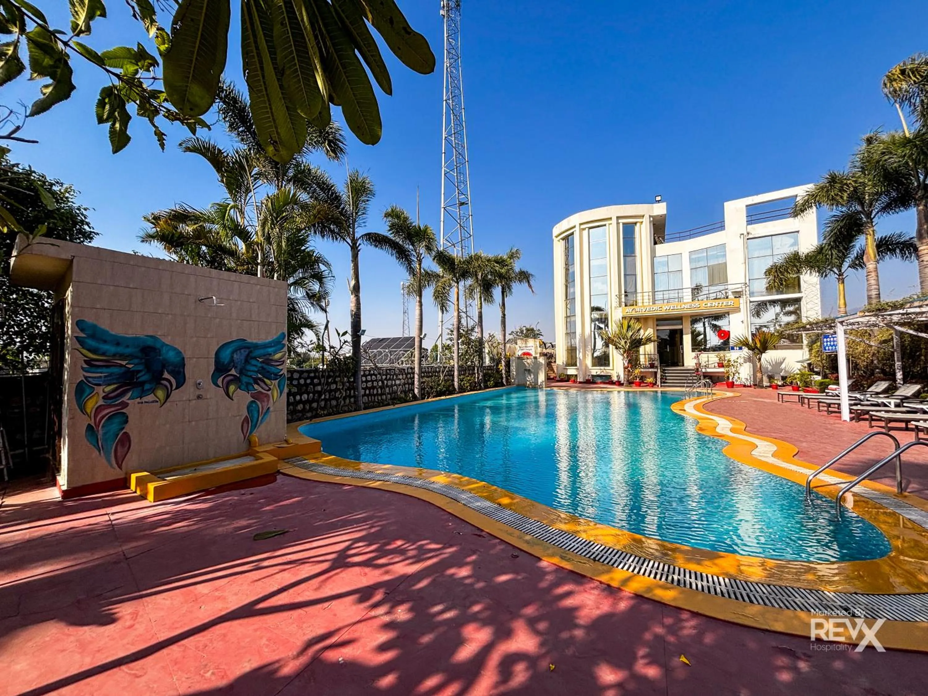 Swimming pool in The Neeraj River Forest Resort Ayurvedic Wellness Center