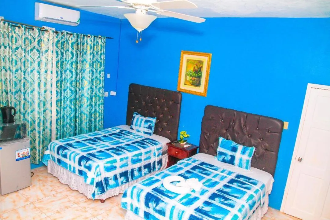 Bed in Dela de-Rose Guest House Negril Jamaica