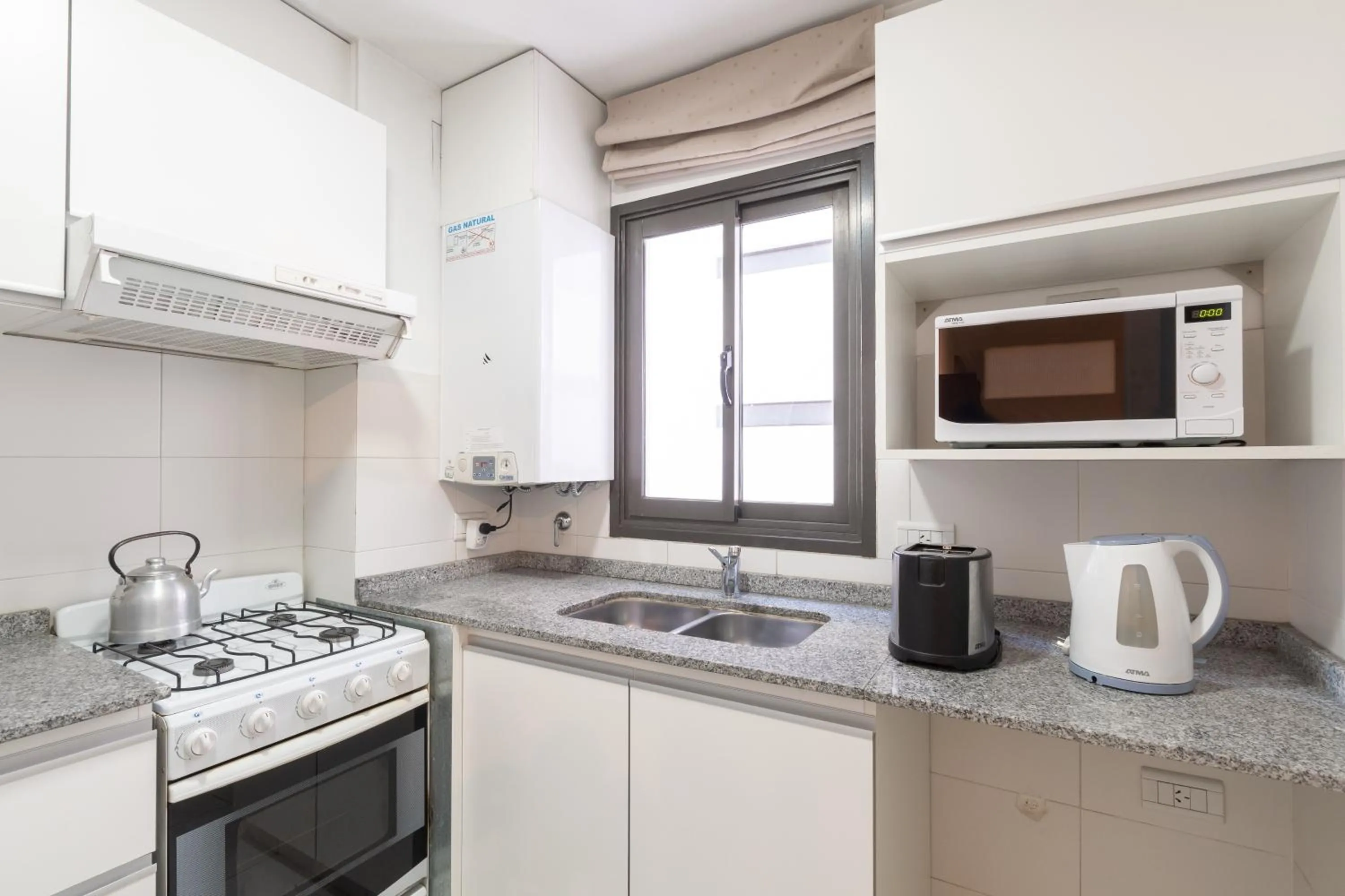 Kitchen or kitchenette in AT Suites