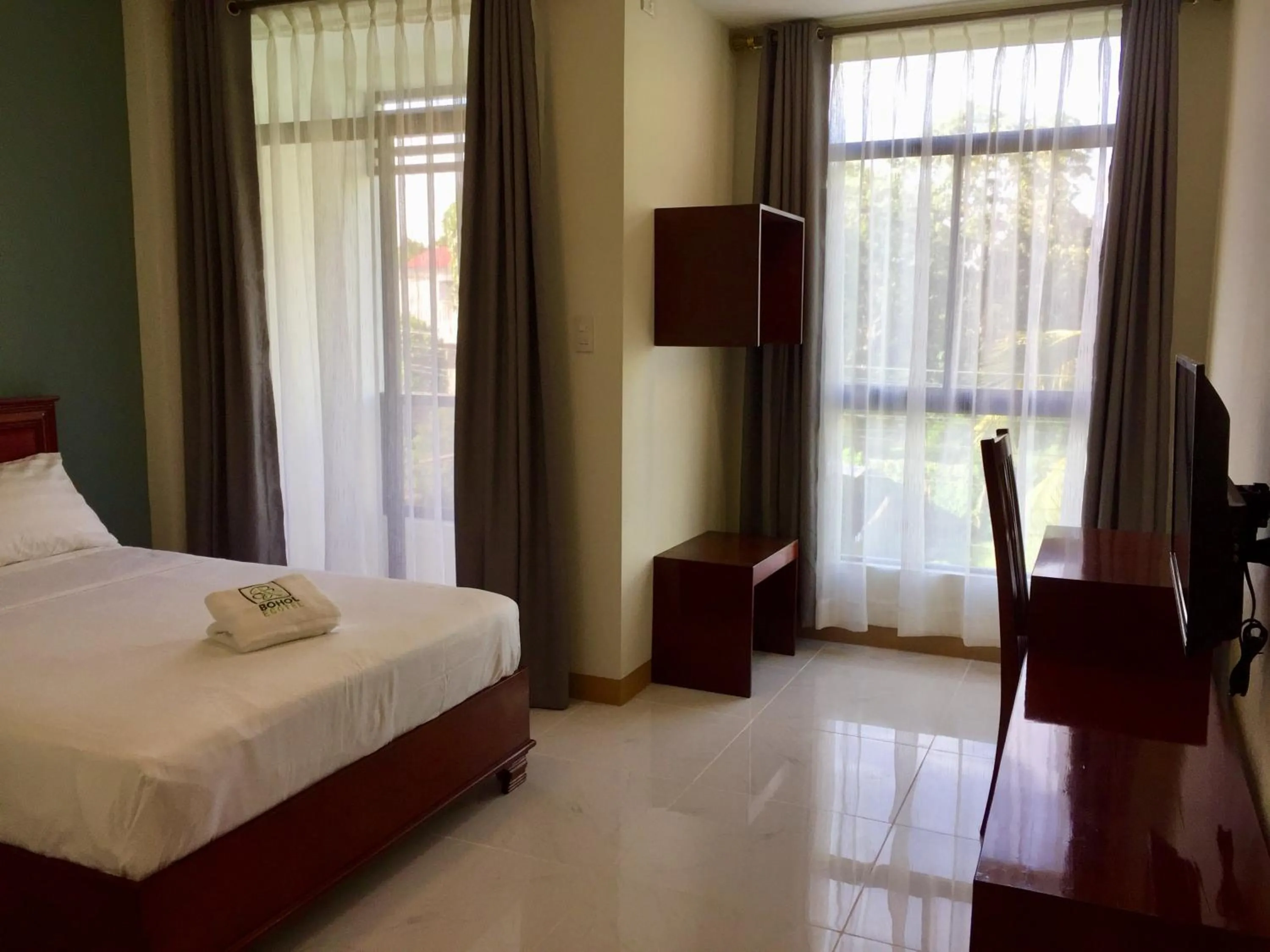 Seating area, Bed in Bohol Ecotel