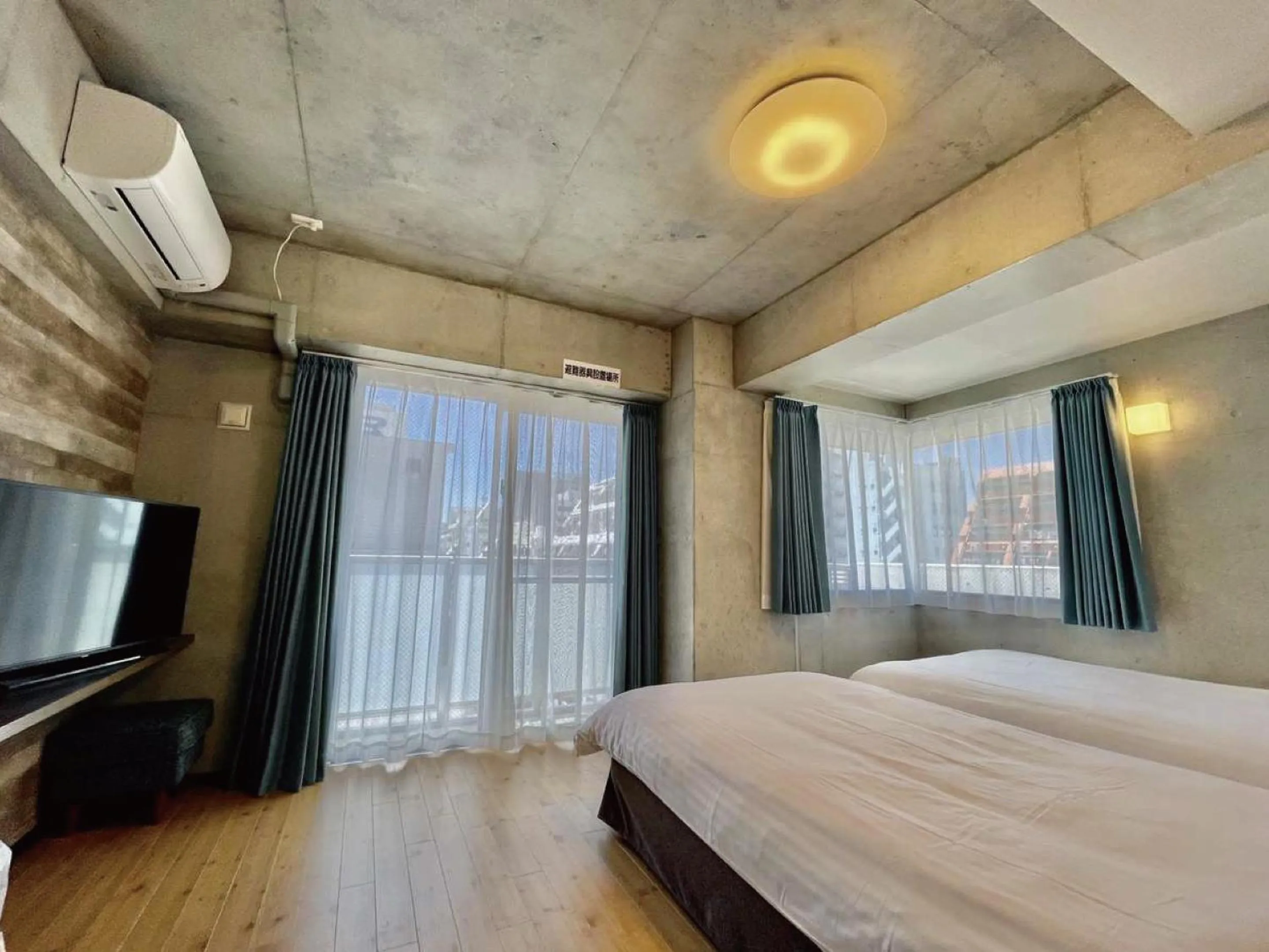 Bed in Infinity Hotel NahaKumoji -SEVEN Hotels and Resorts-