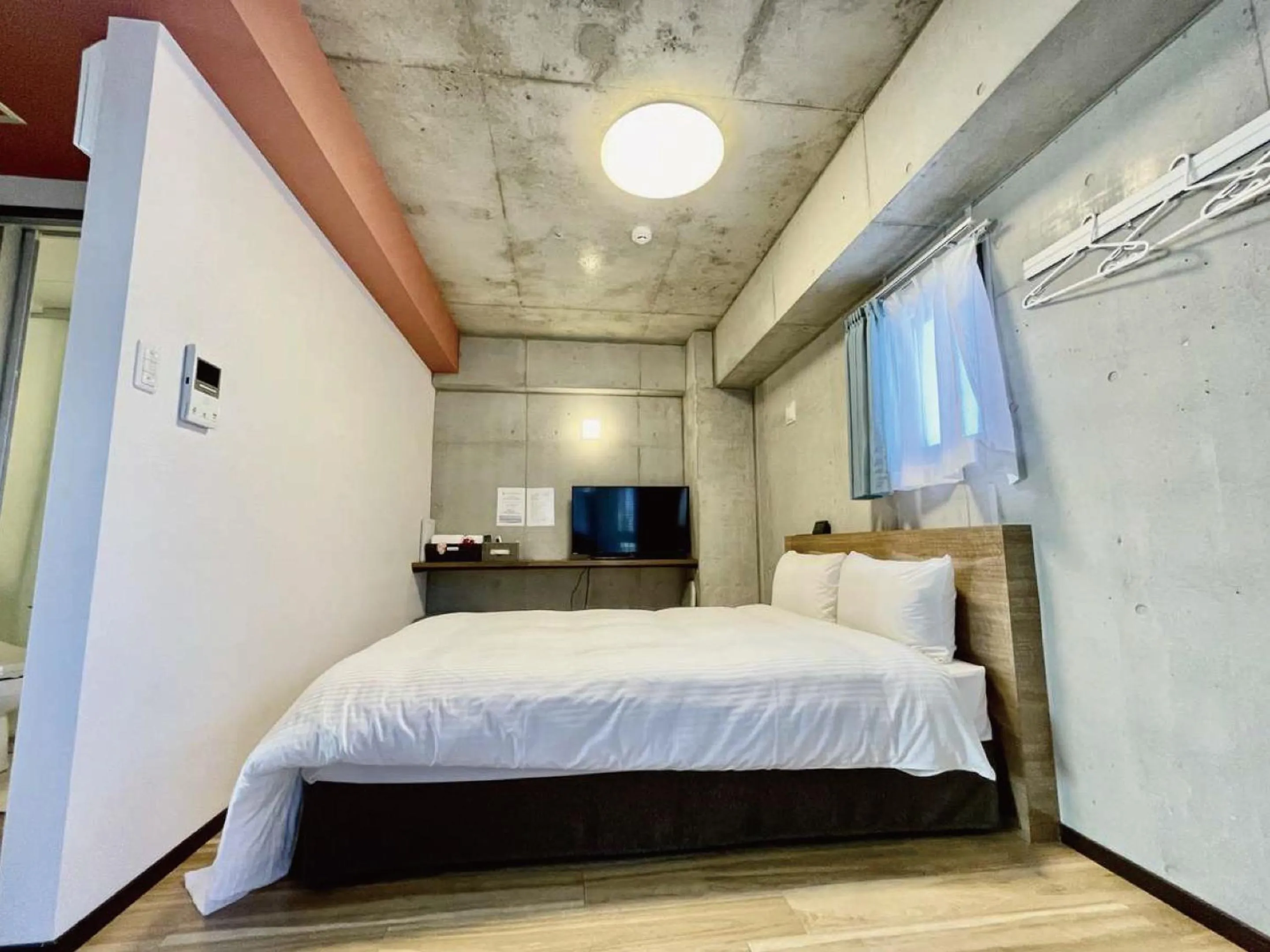 Bed in Infinity Hotel NahaKumoji -SEVEN Hotels and Resorts-