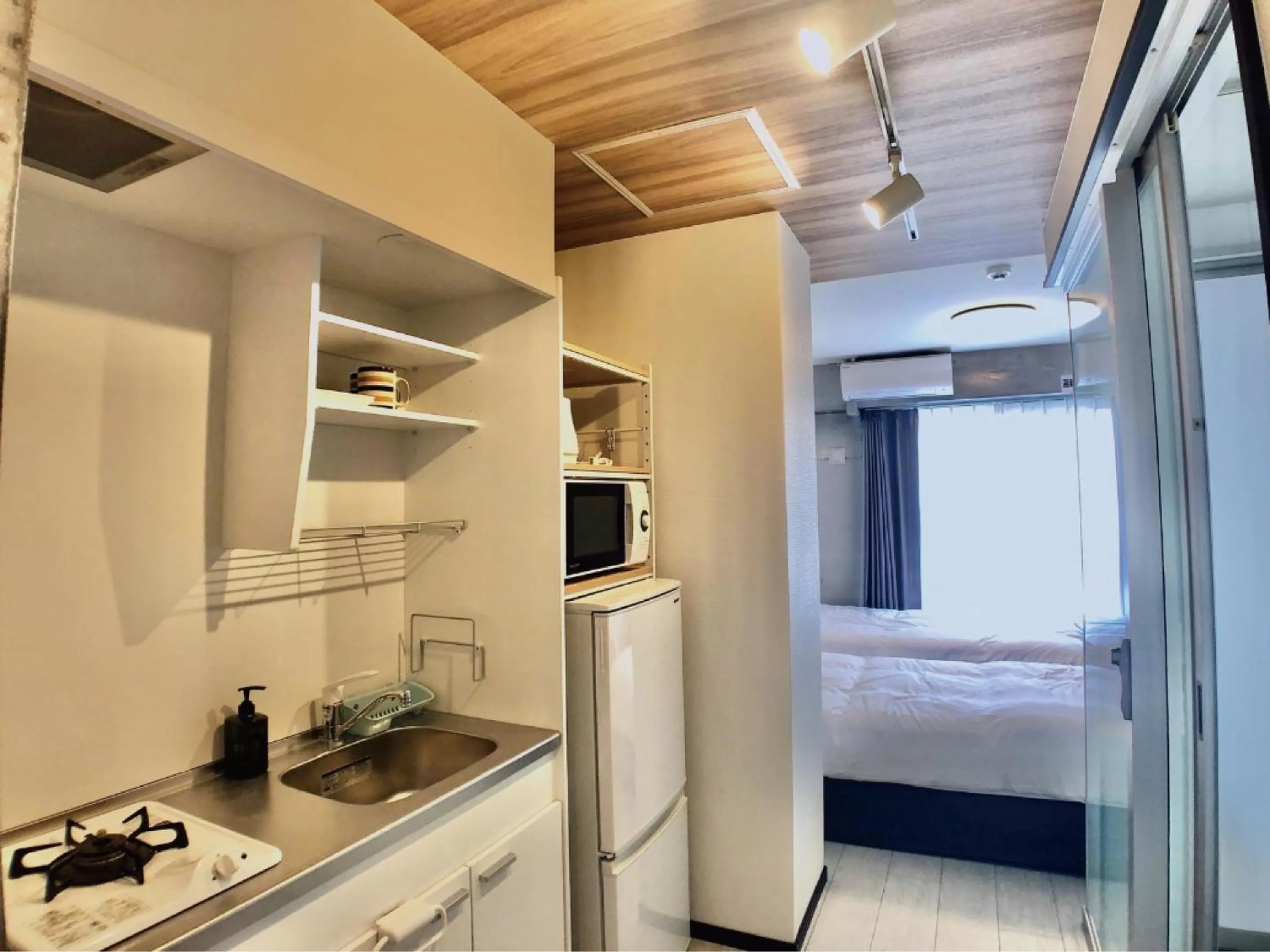 Kitchen or kitchenette, Bed in Infinity Hotel NahaKumoji -SEVEN Hotels and Resorts-