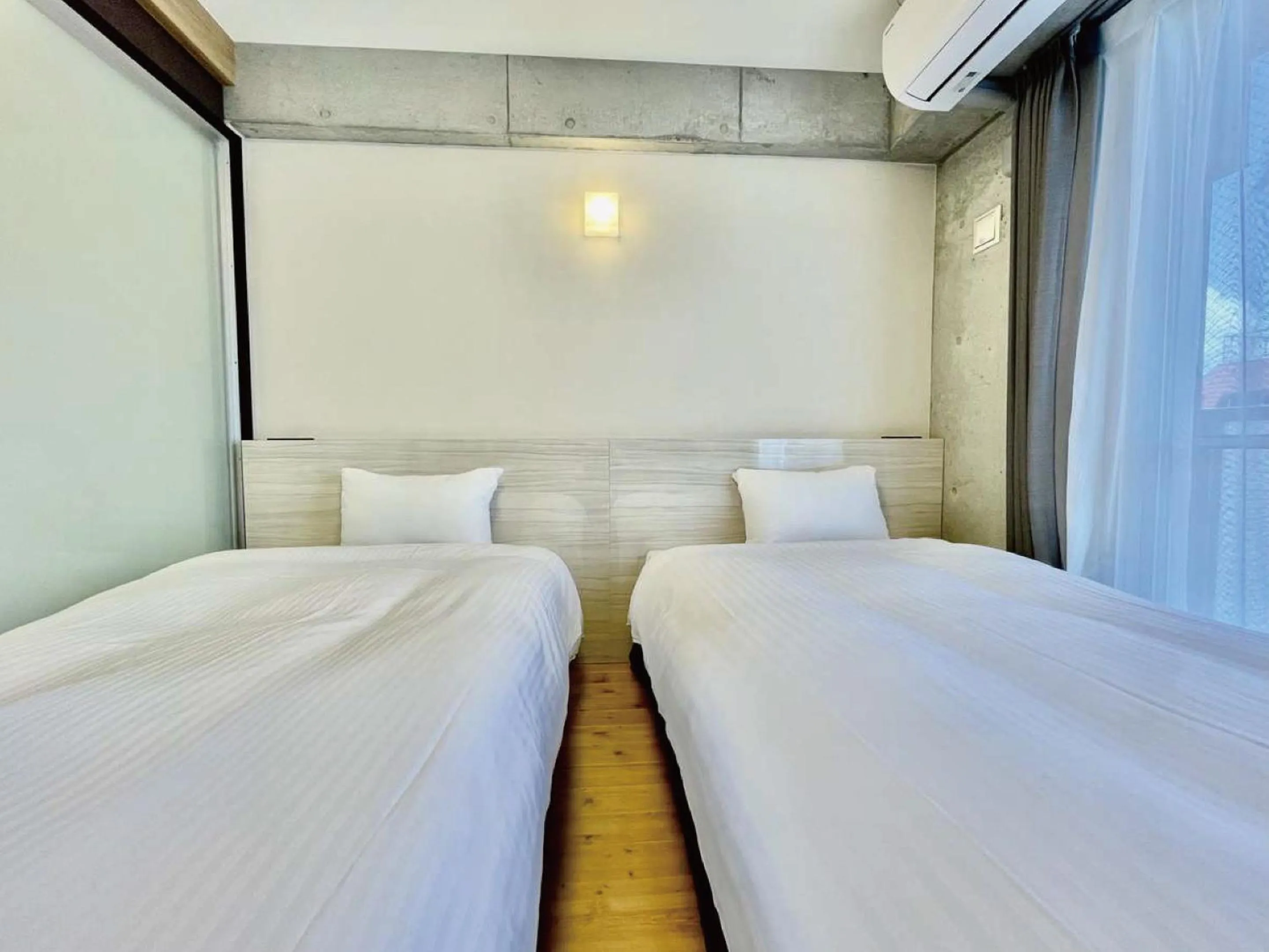 Bed in Infinity Hotel NahaKumoji -SEVEN Hotels and Resorts-