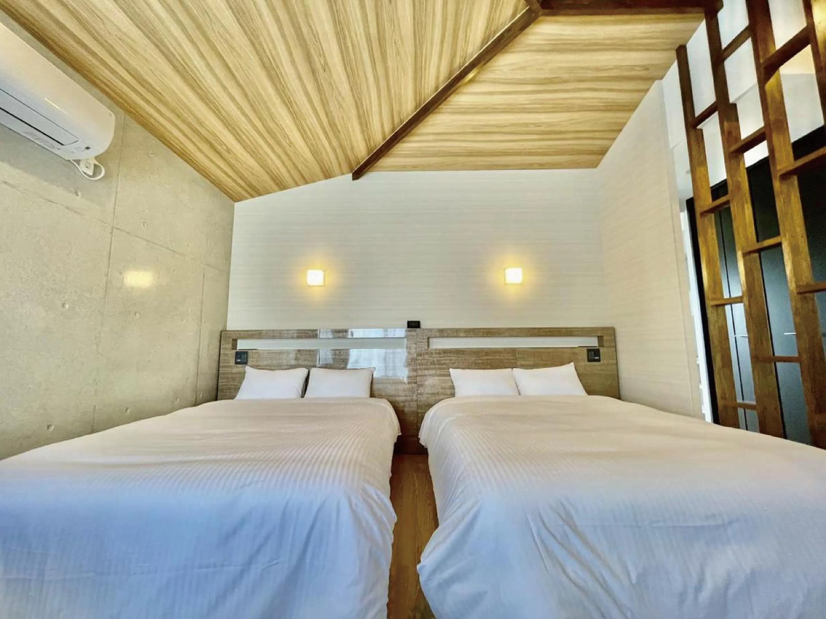 Bed in Infinity Hotel NahaKumoji -SEVEN Hotels and Resorts-