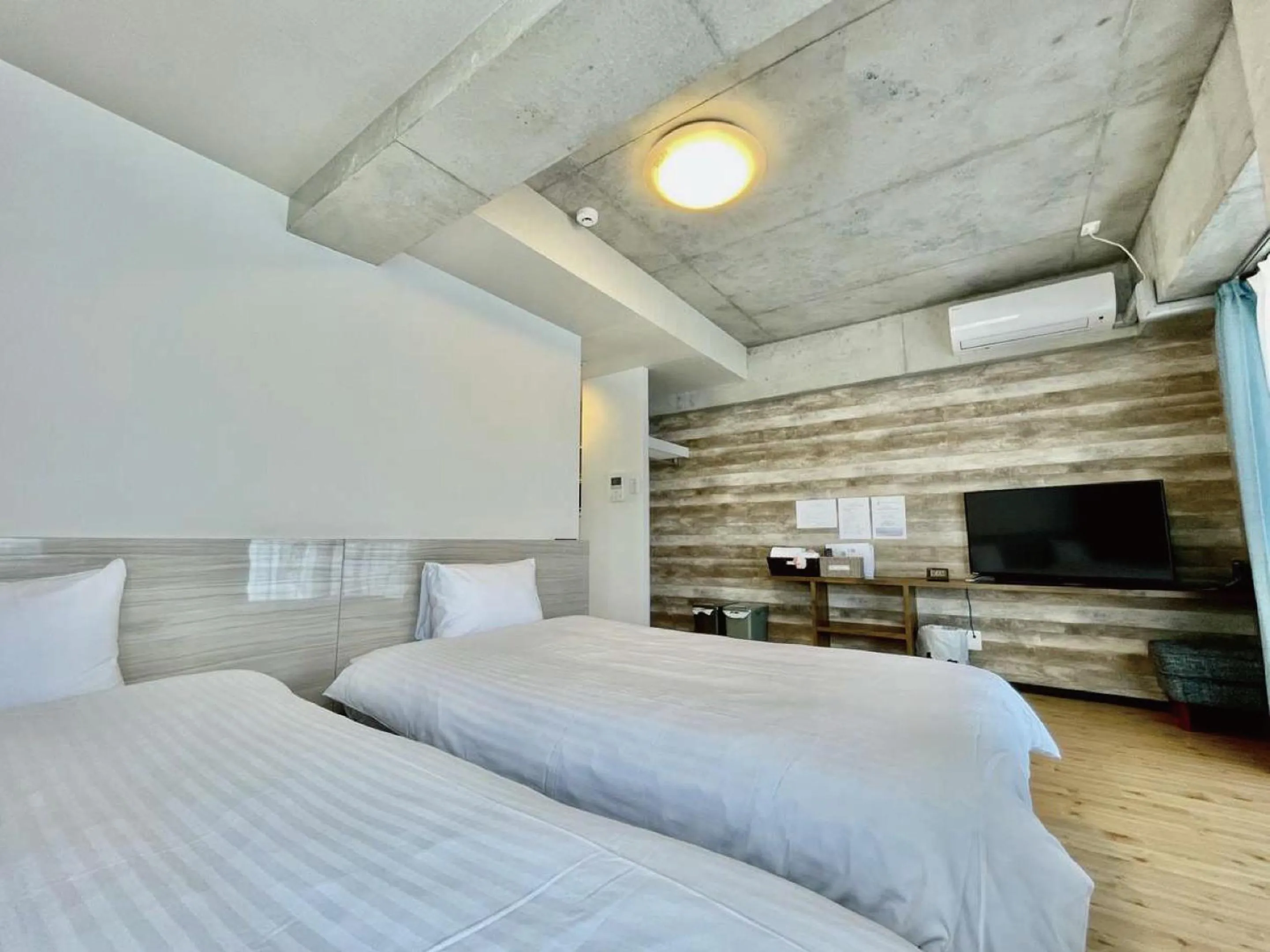 Bed in Infinity Hotel NahaKumoji -SEVEN Hotels and Resorts-