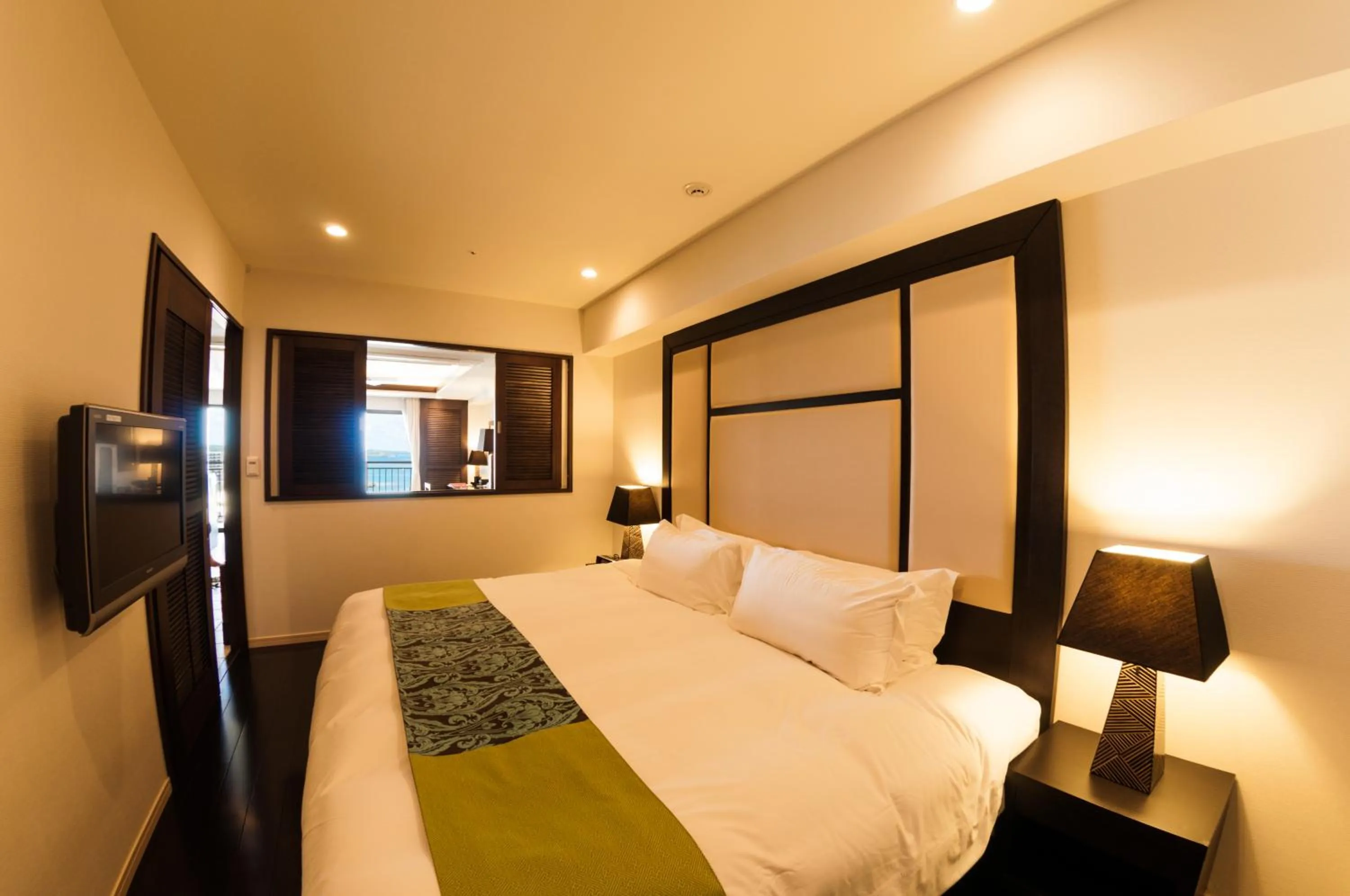 Bed in Kafuu Resort Fuchaku Condo Hotel