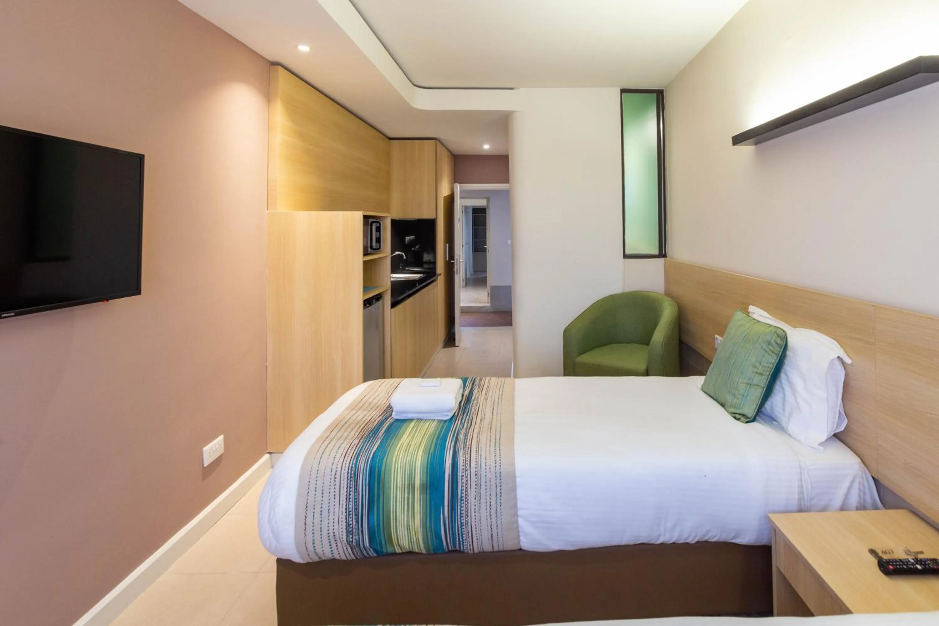 Photo of the whole room, Bed in Kozi Suites Nairobi Airport