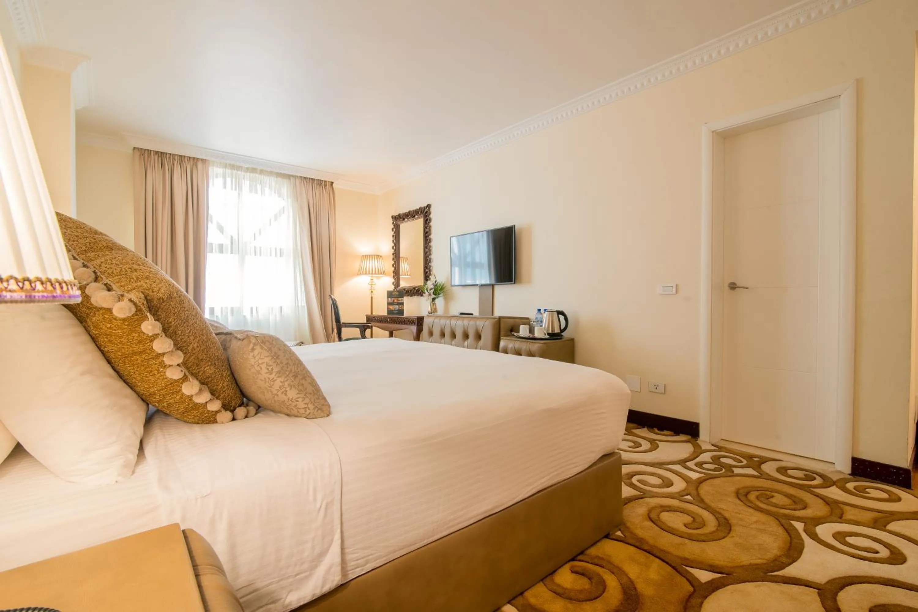 Bed in The Grand Palace Hotel