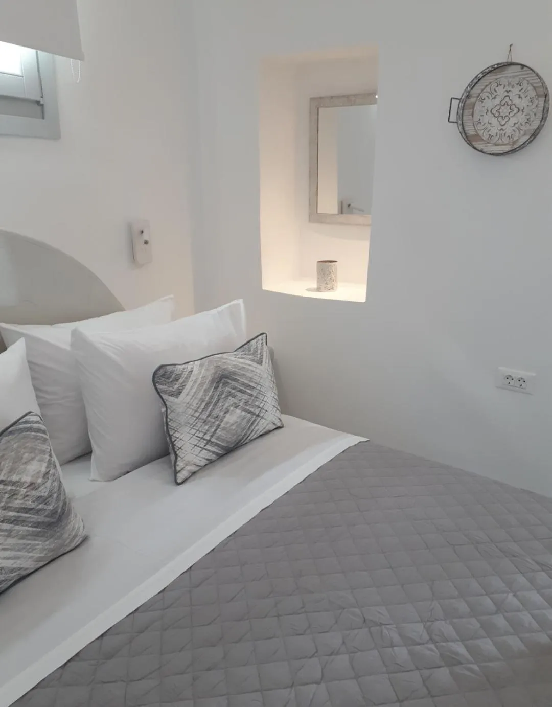 Bed in Golden Stone Santorini Suites