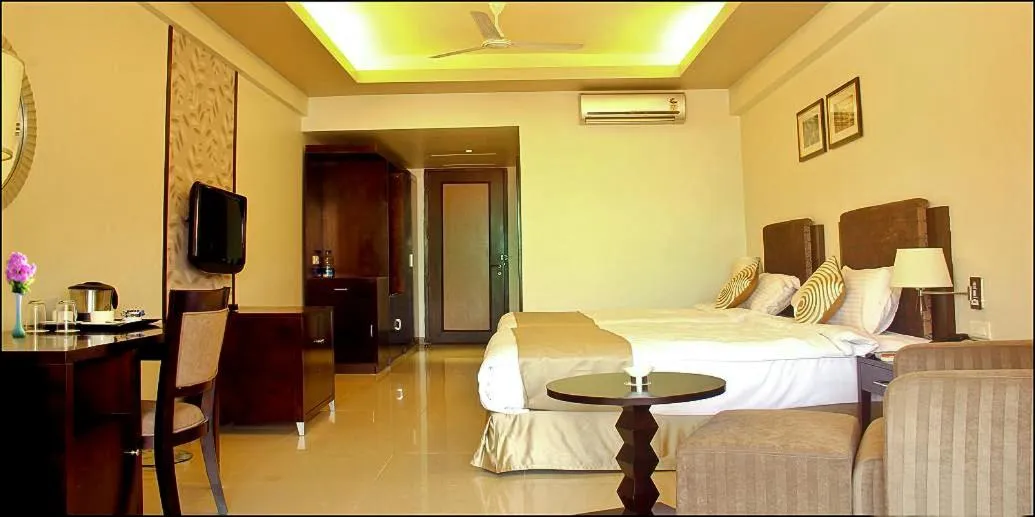Photo of the whole room, Bed in Pramod Convention & Club Resort