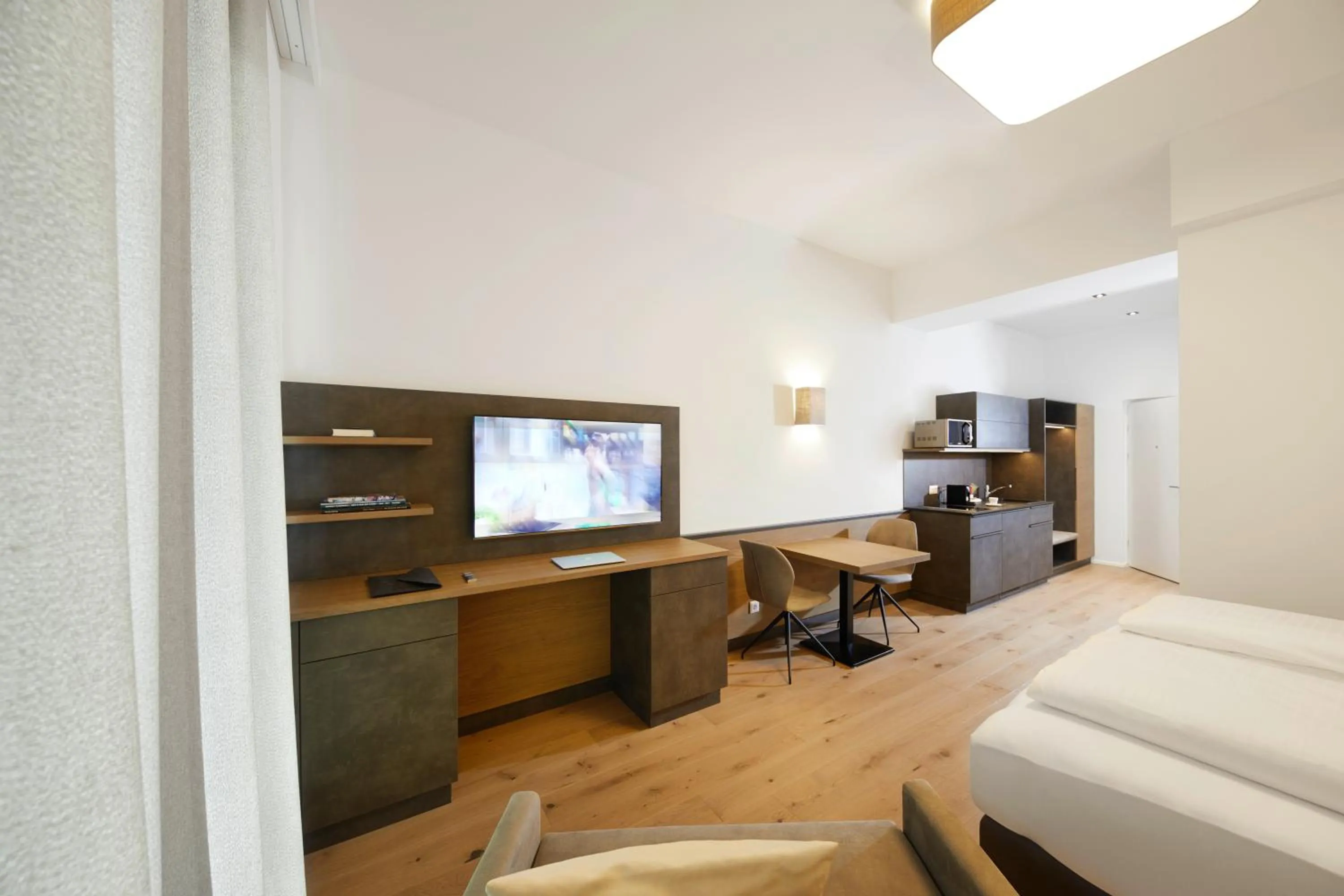 Living room, Bed in Hotel Gösser Bräu