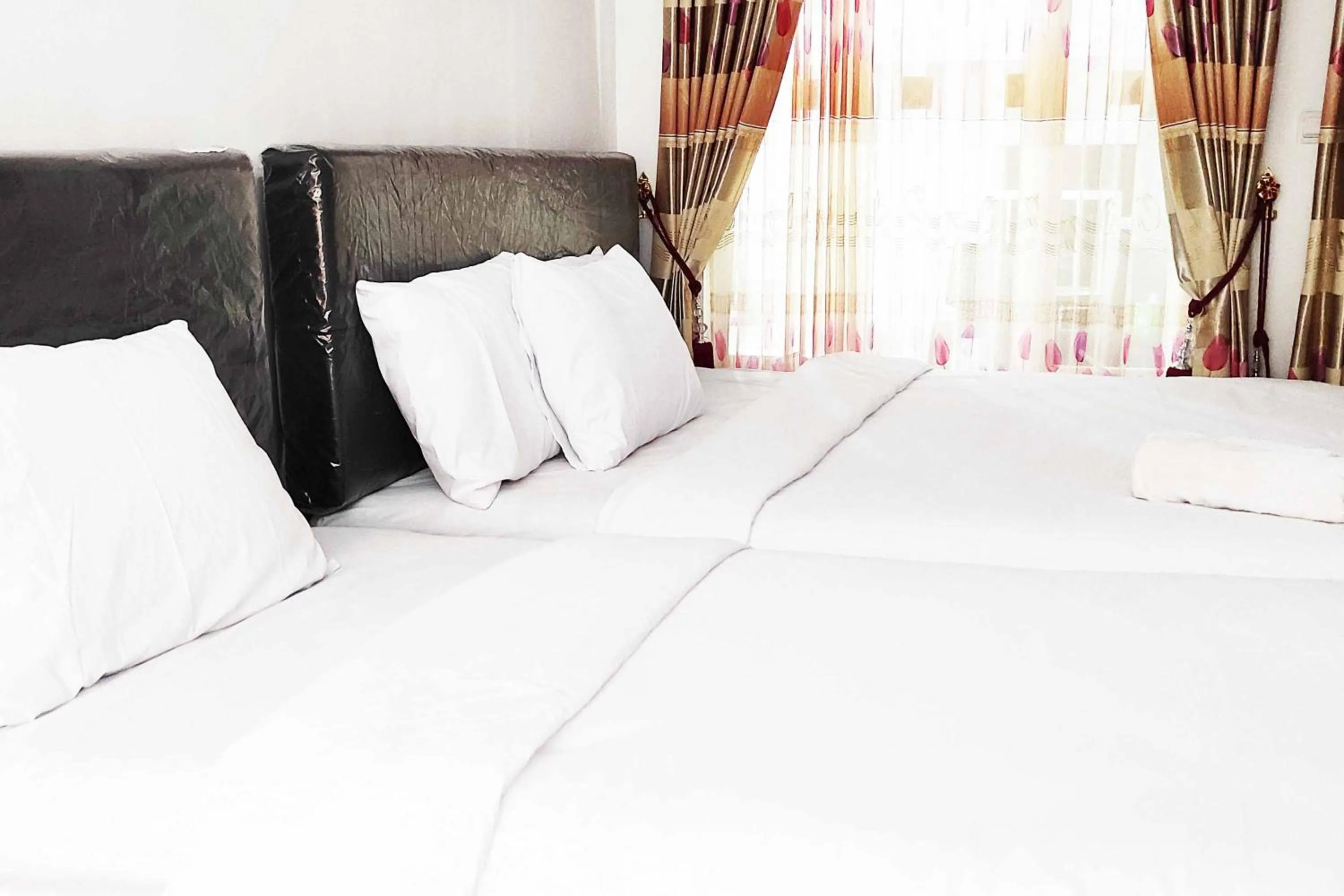 Bed in Pertiwi Homestay Near Museum Angkut Batu Mitra RedDoorz