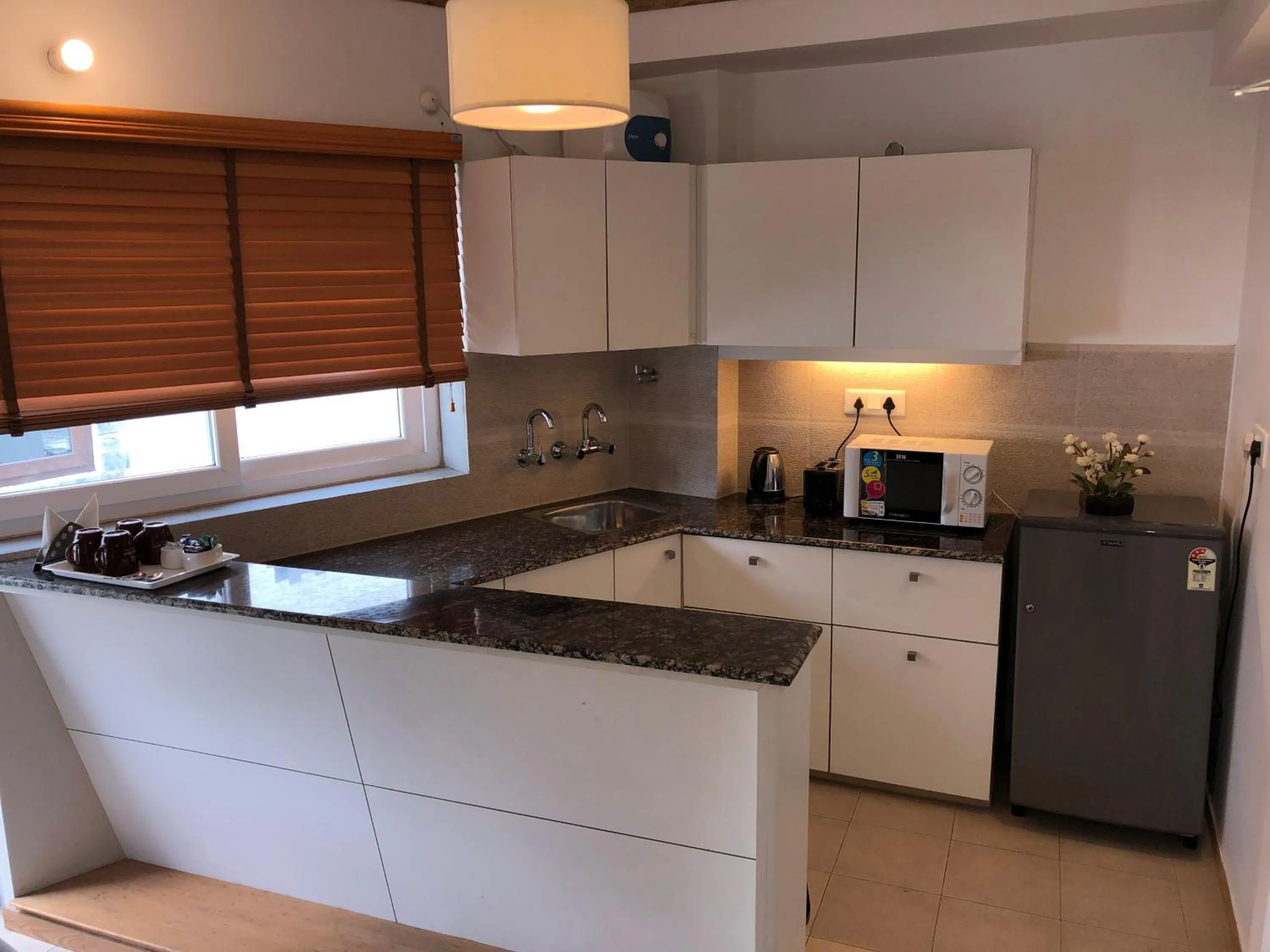 Communal kitchen in The Pinewood, Nainital by Leisure Hotels