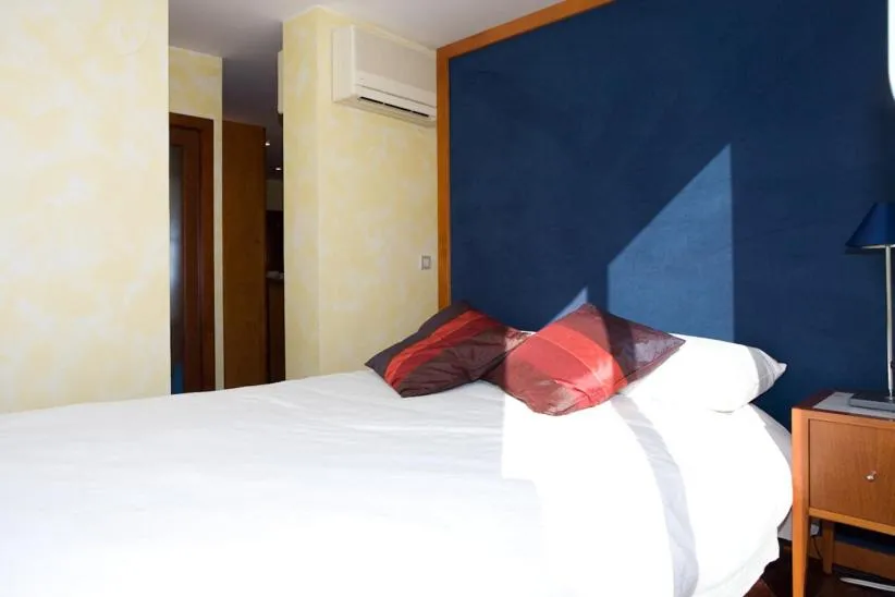 Bed in Gaudi penthouse with terrace views