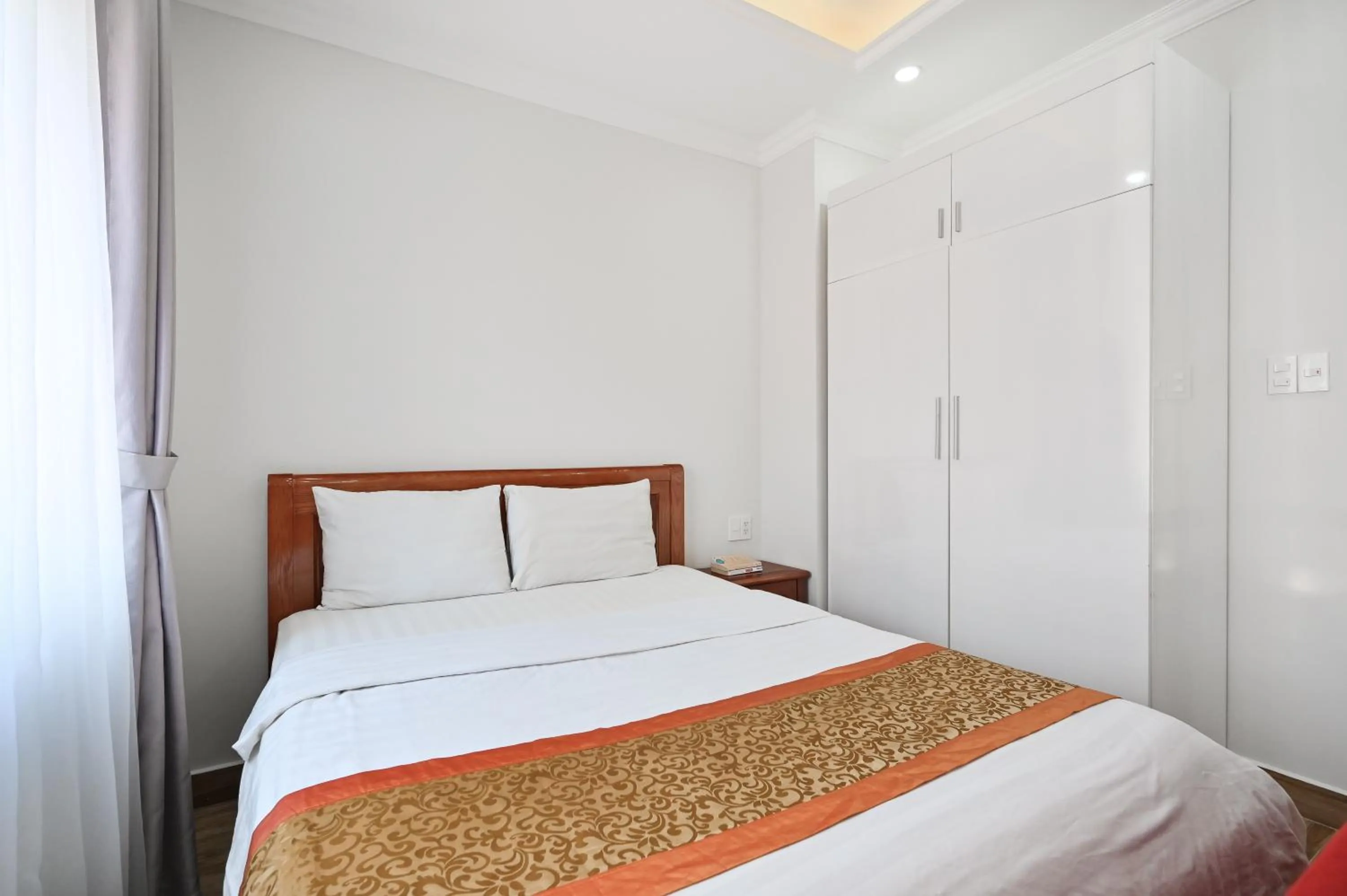 Bed in Genie Hotel & Serviced Apartments