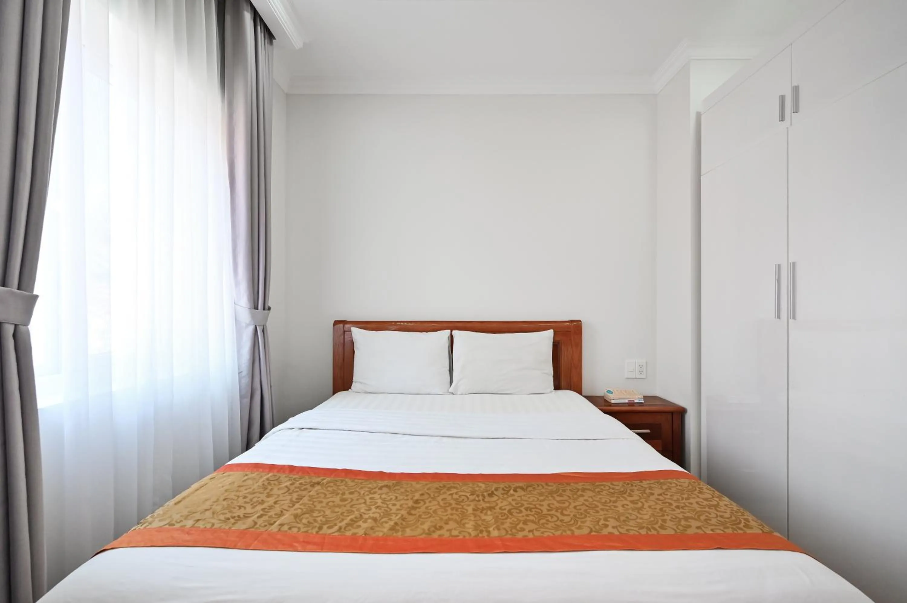 Bed in Genie Hotel & Serviced Apartments