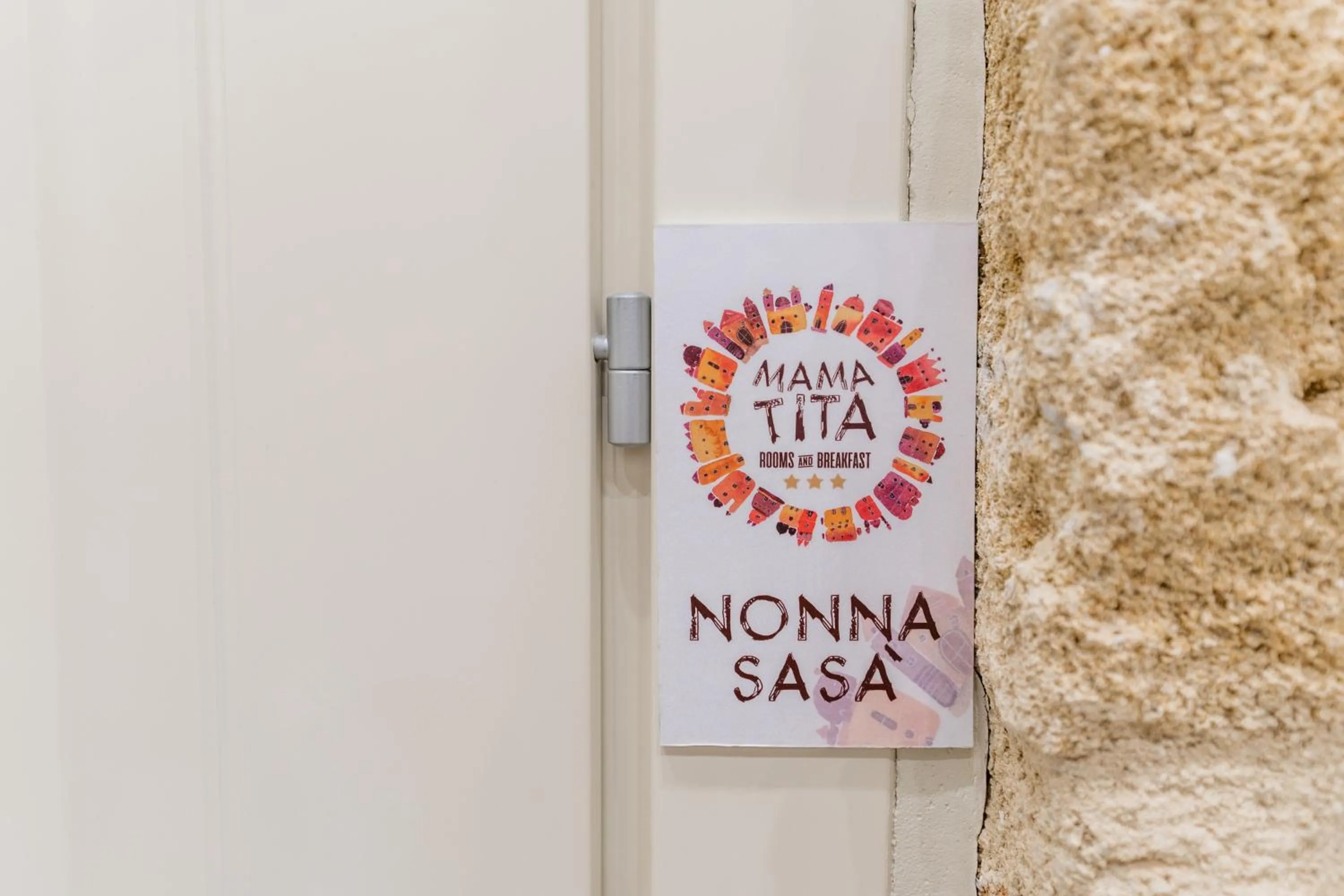 Property logo or sign in Mama Tita Rooms and Breakfast