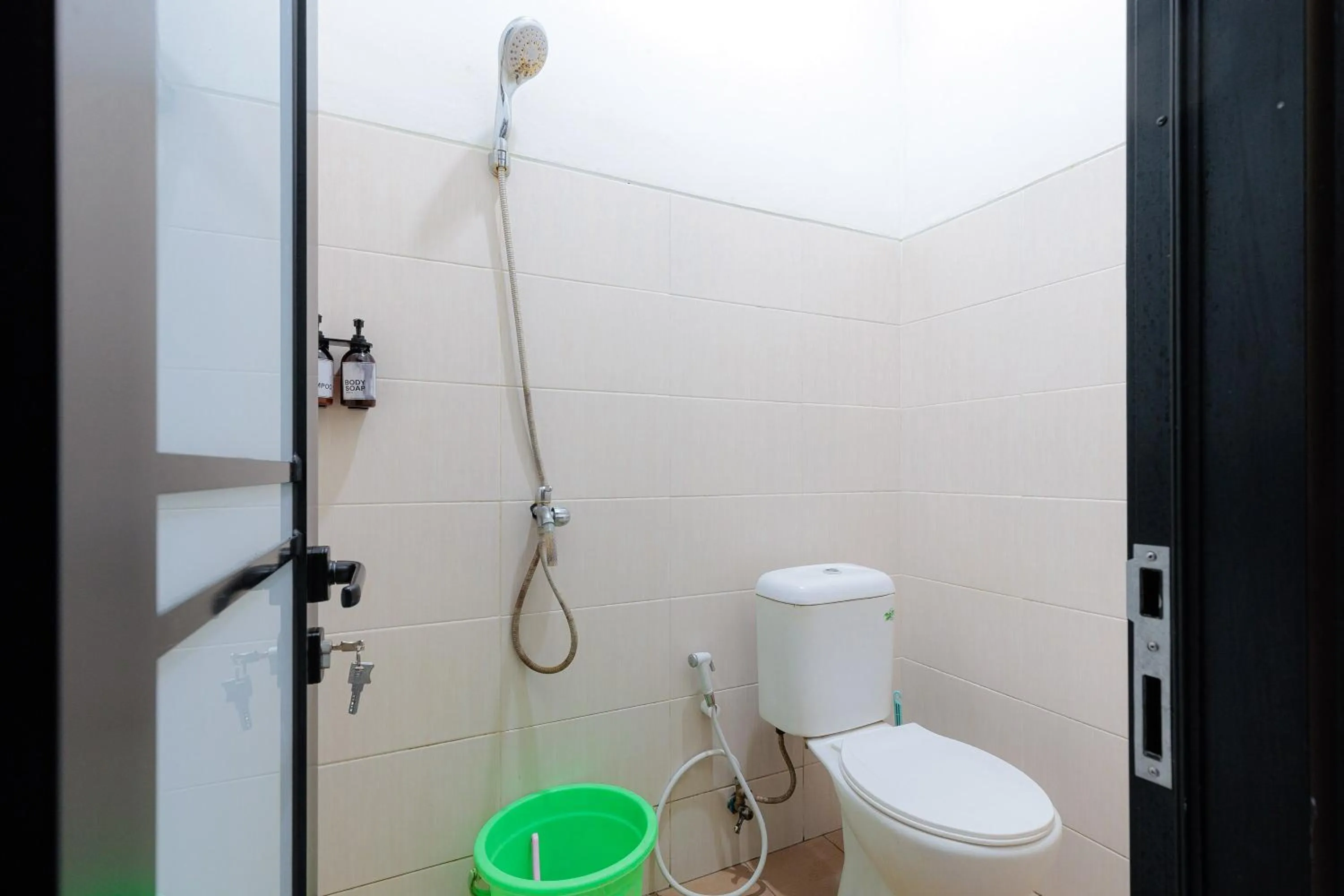 Bathroom in RedDoorz Syariah at Hotel Tiga ER near Karawang Central Plaza