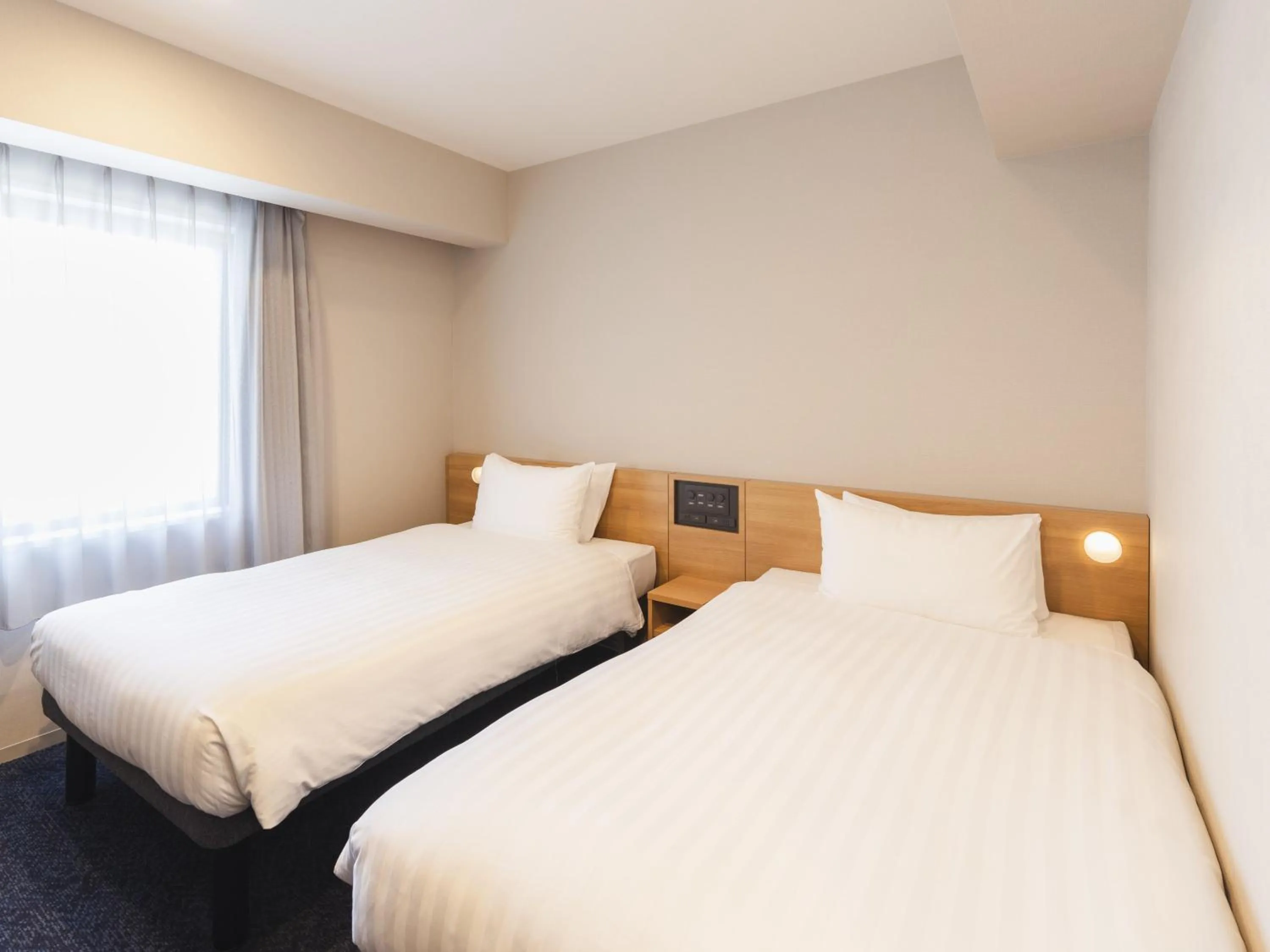 Bed in Sotetsu Fresa Inn Hiroshima