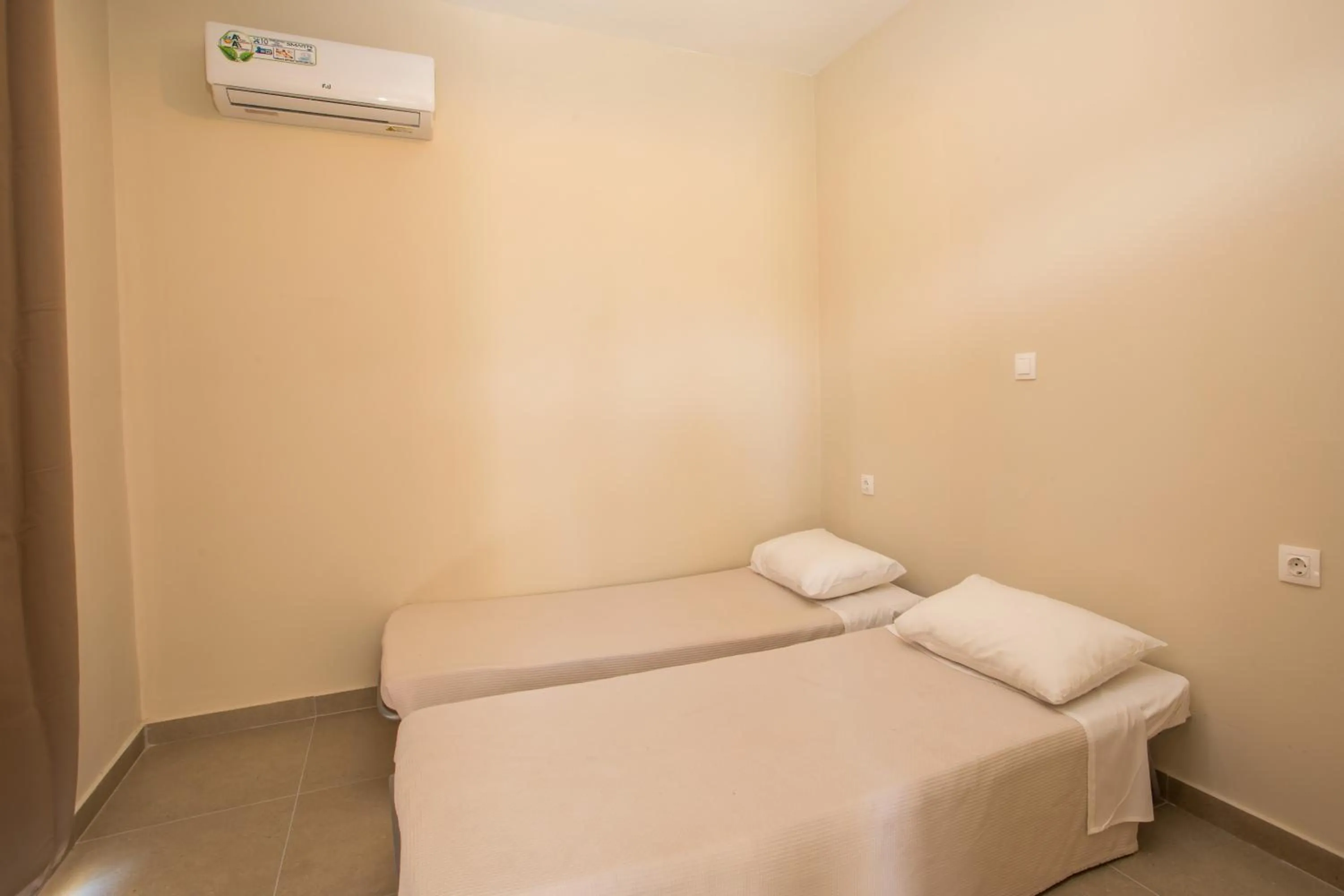 Bed in Atma Beach Rooms & Suites