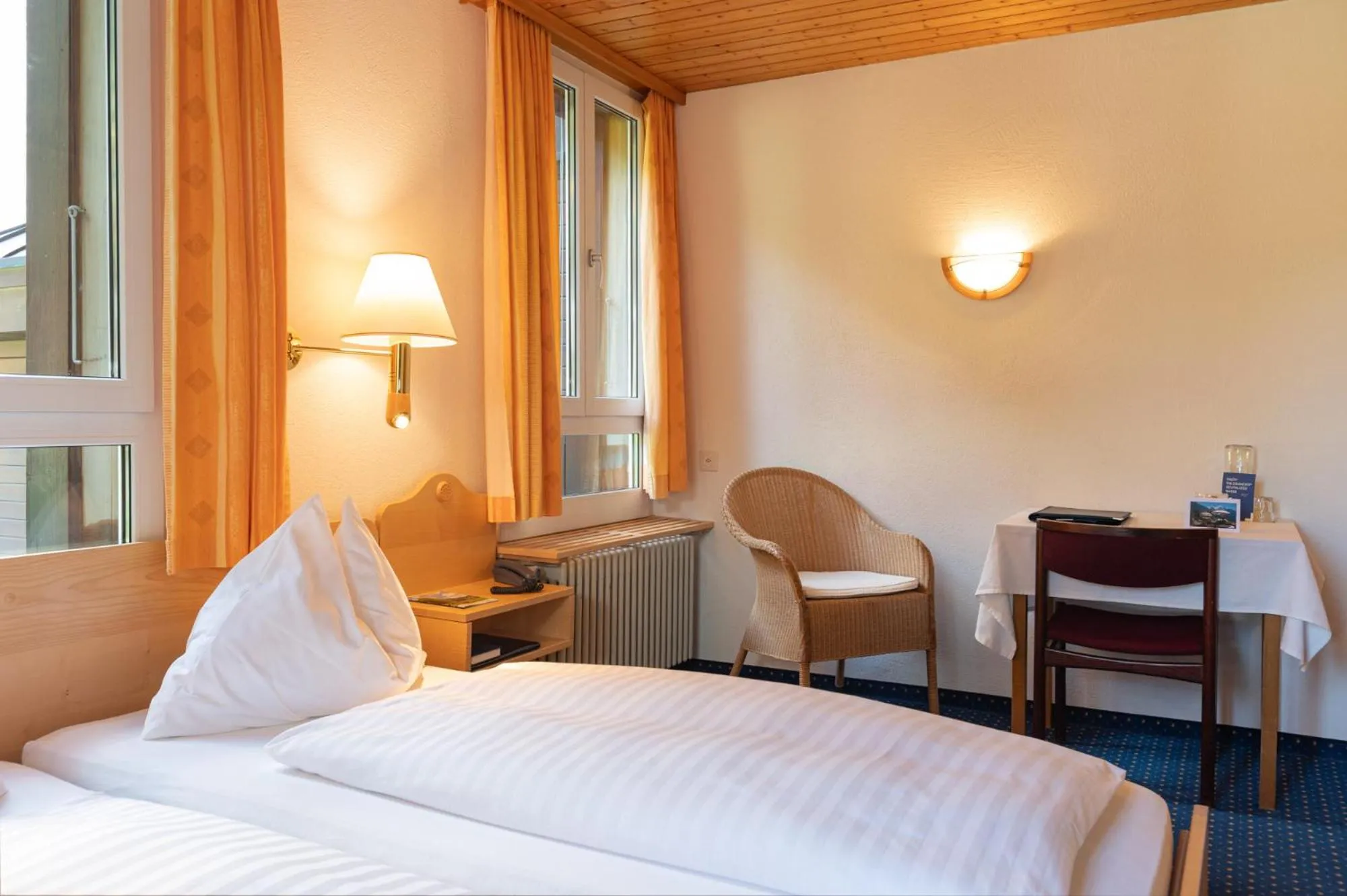 Bed in Hotel Bellevue - Traditional Swiss Hideaway