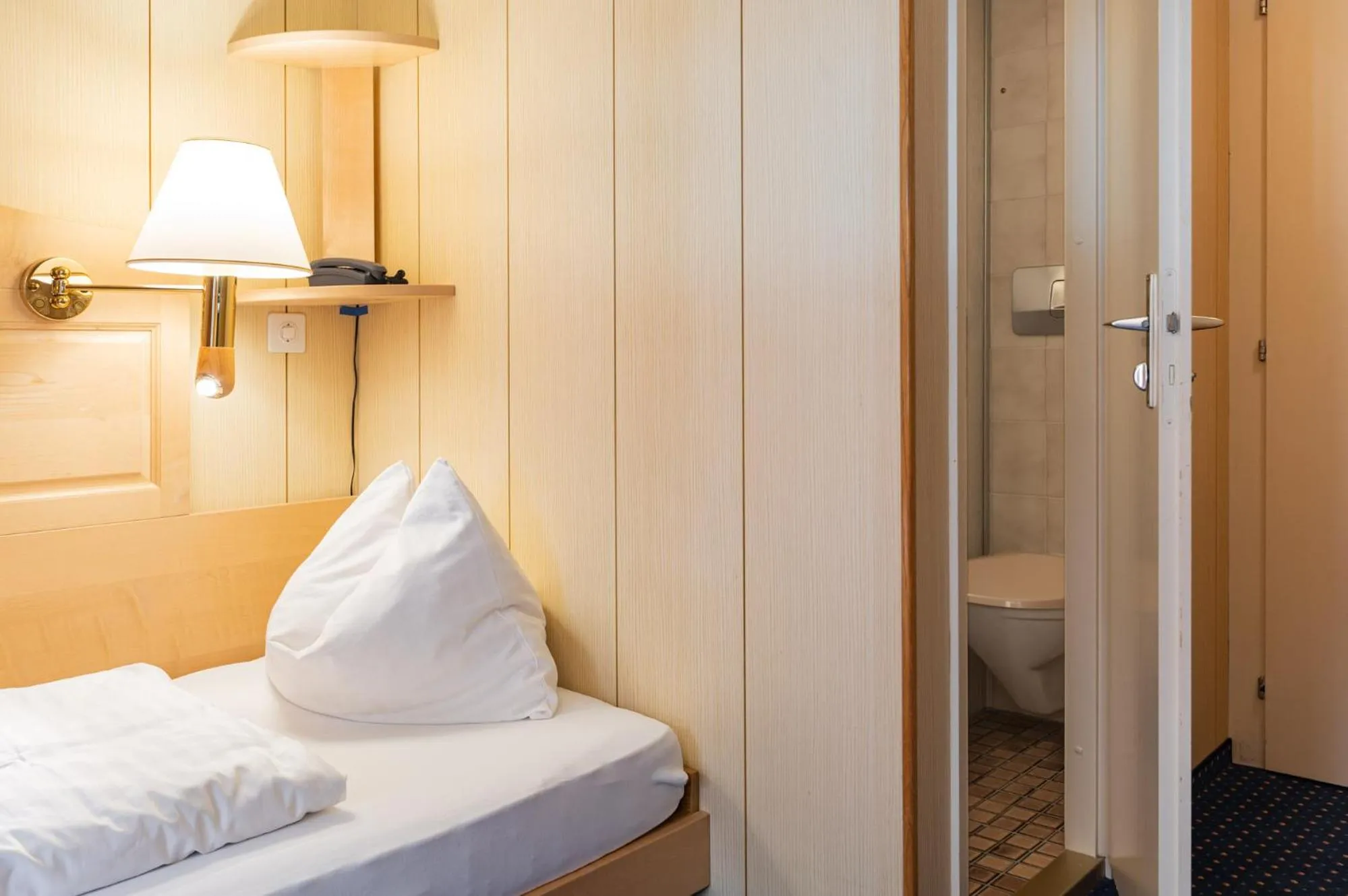 Bed in Hotel Bellevue - Traditional Swiss Hideaway