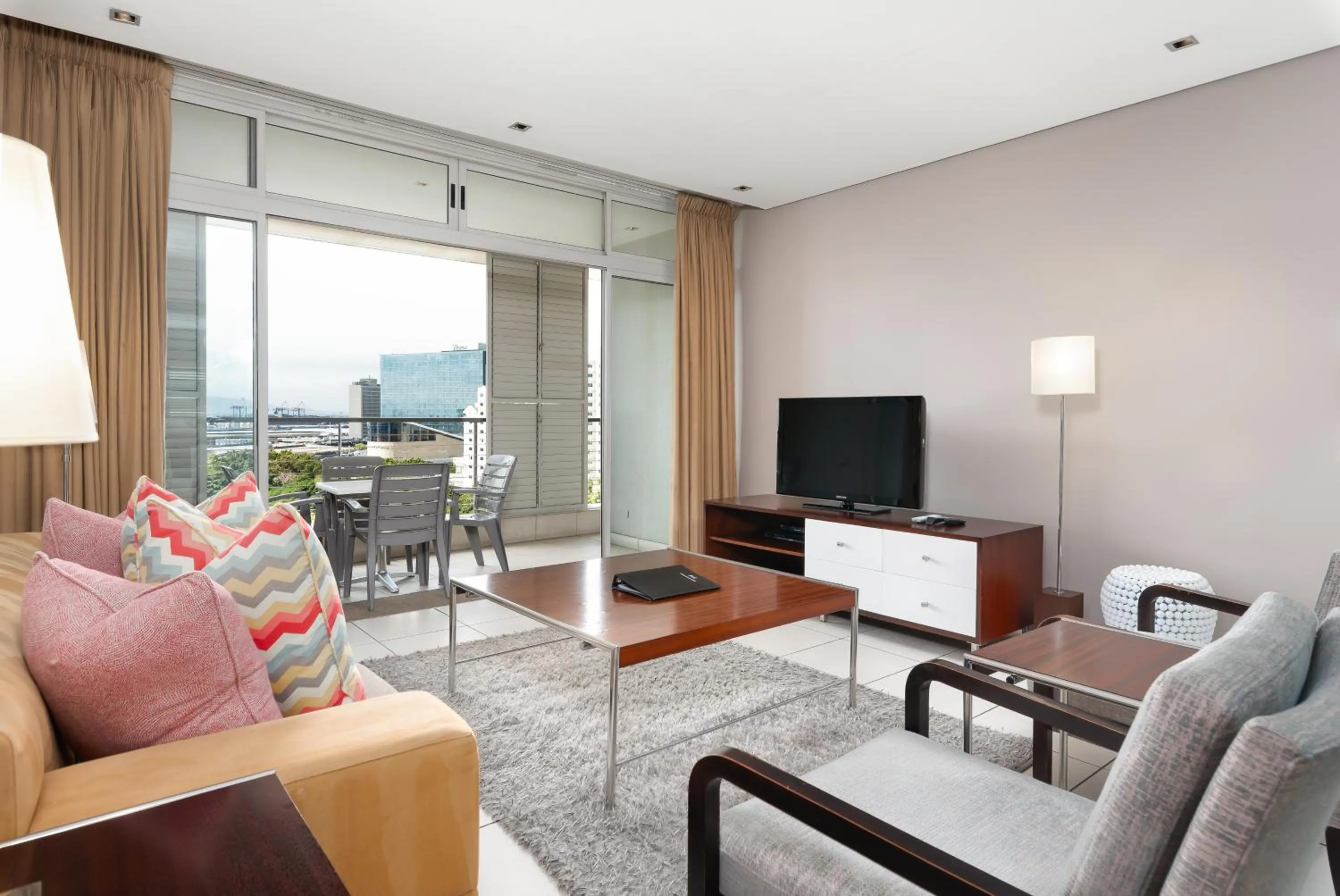 TV and multimedia, Seating Area in HarbourEdge Suites by Totalstay
