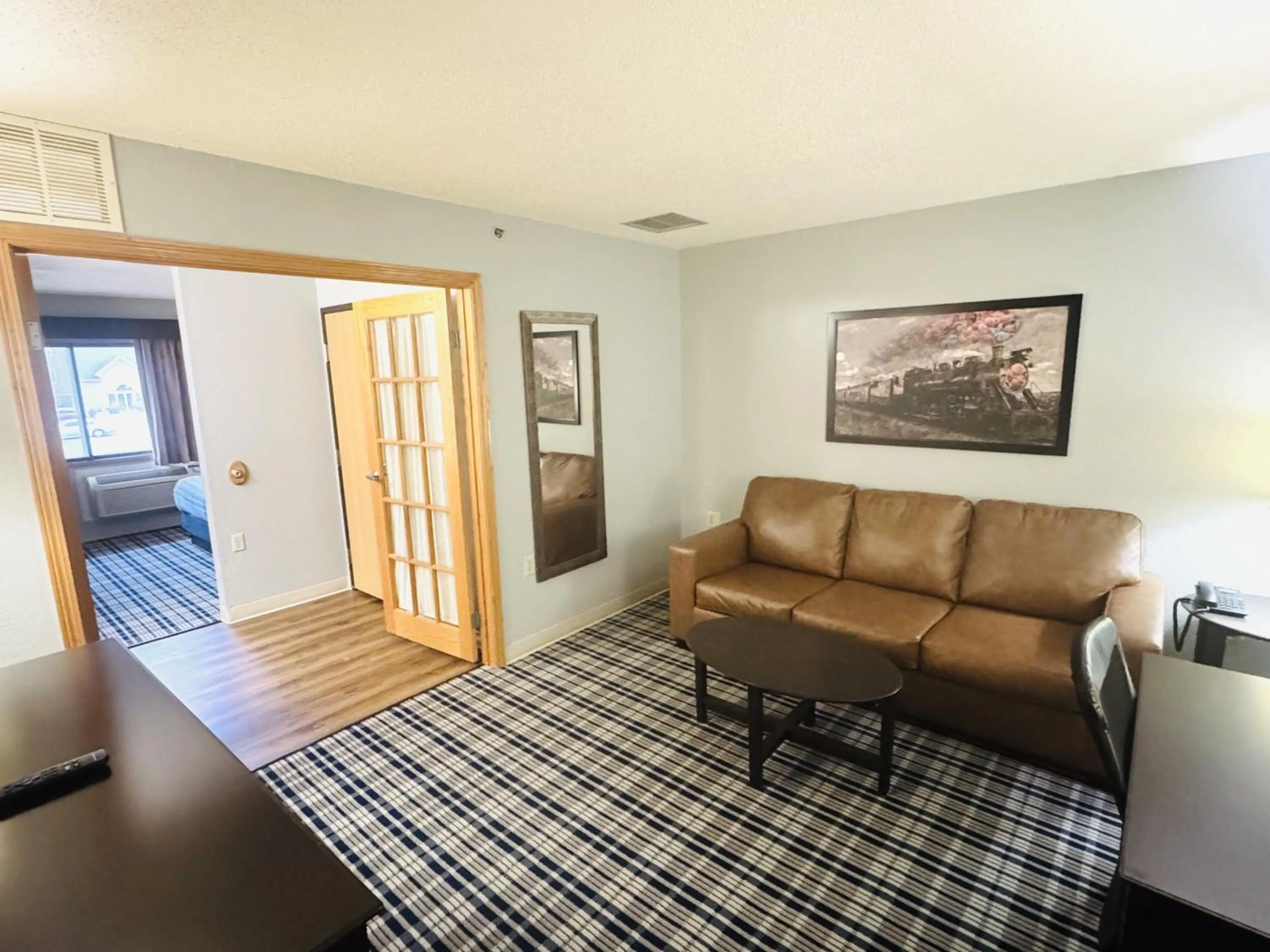 Communal lounge/ TV room in AmericInn by Wyndham Ames