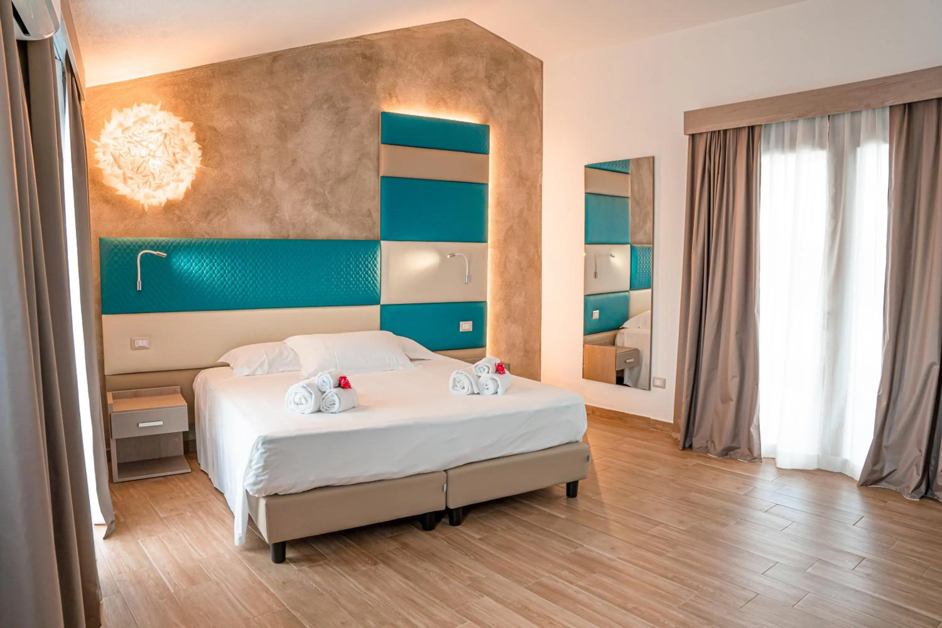 Bed in AQUA SARDINIA boutique hotel