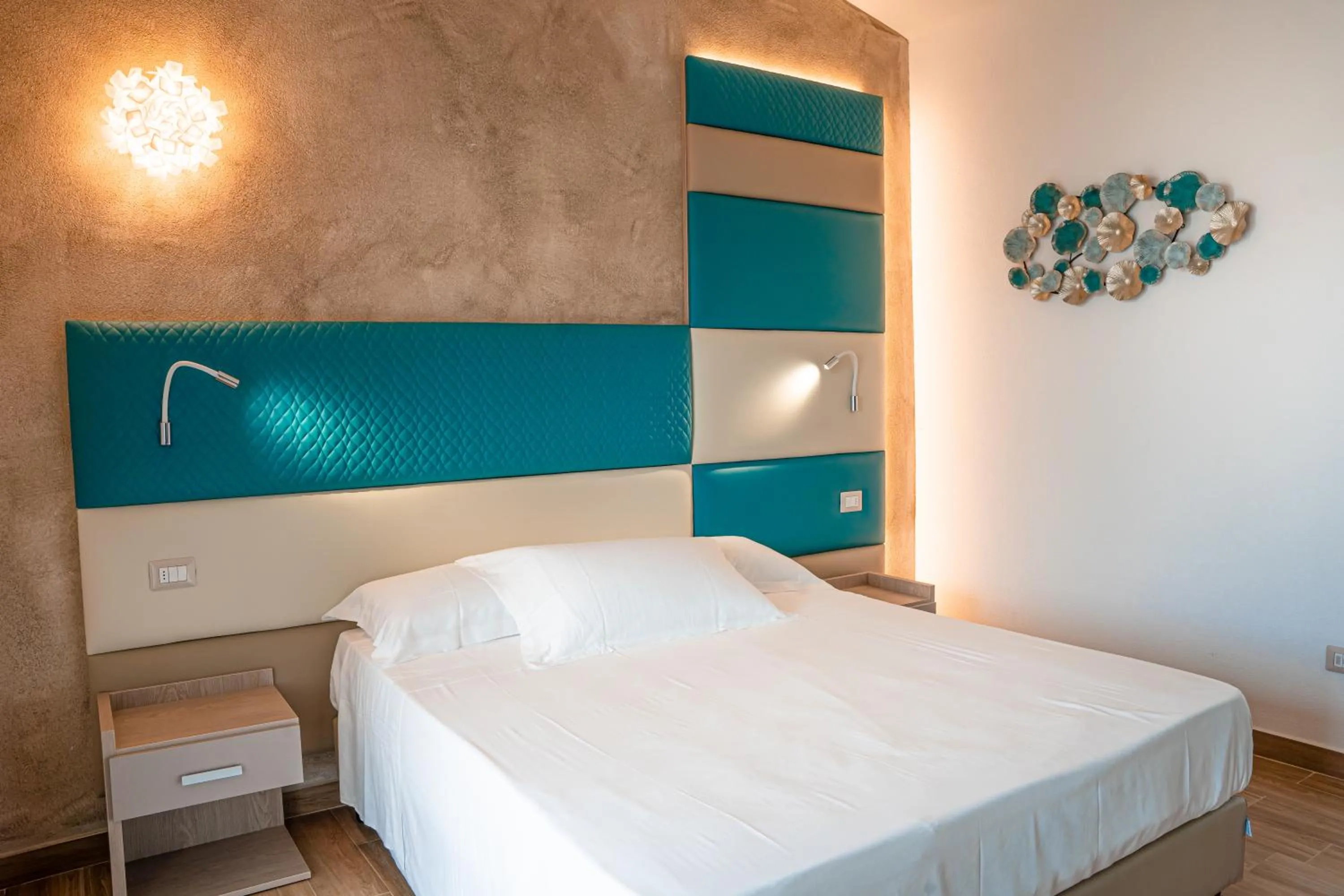 Bed in AQUA SARDINIA boutique hotel