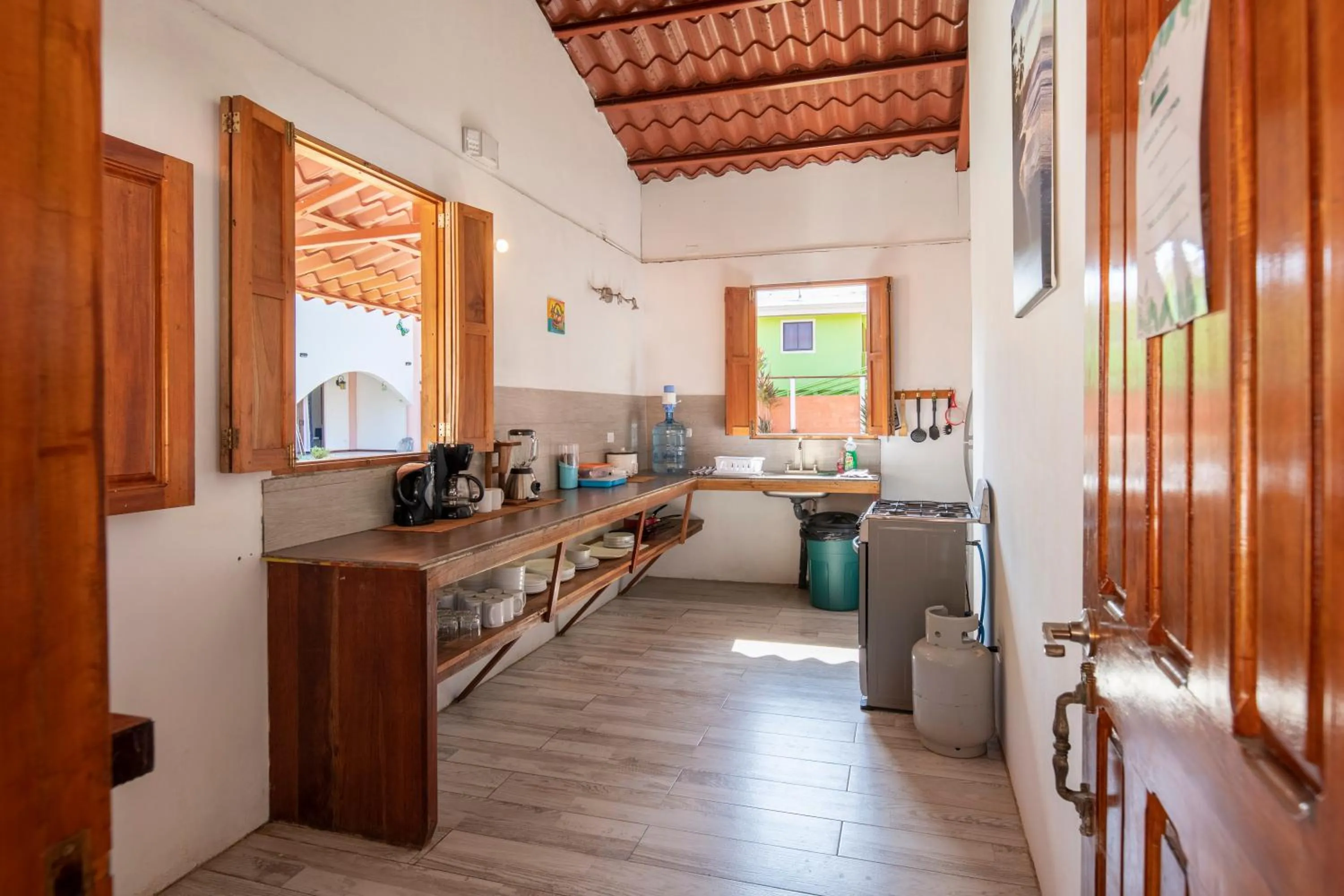 Communal kitchen in Pangea Lodge with Shared Pool at the Heart of Manzanillo