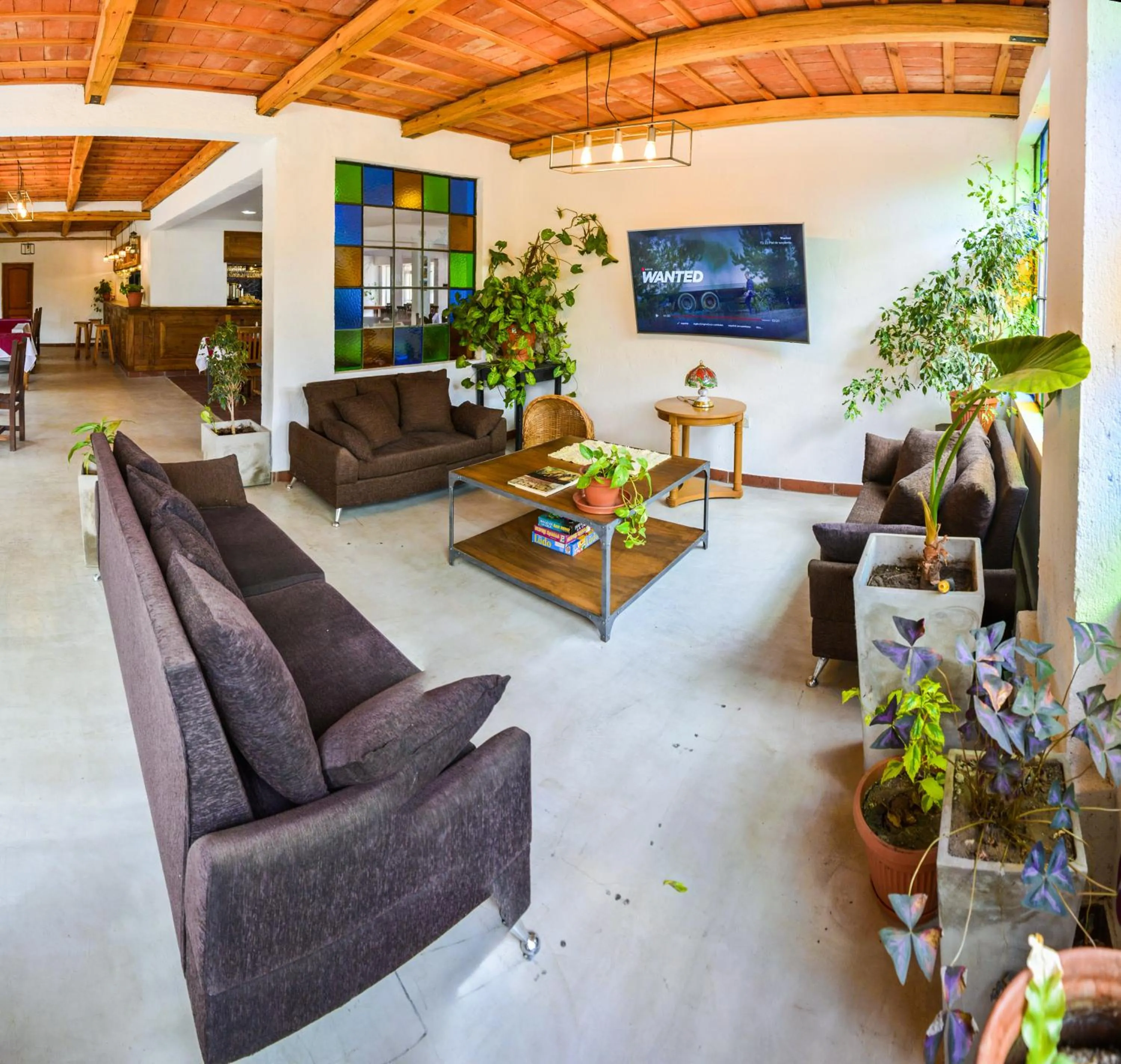 Communal lounge/ TV room in La Candida Hotel