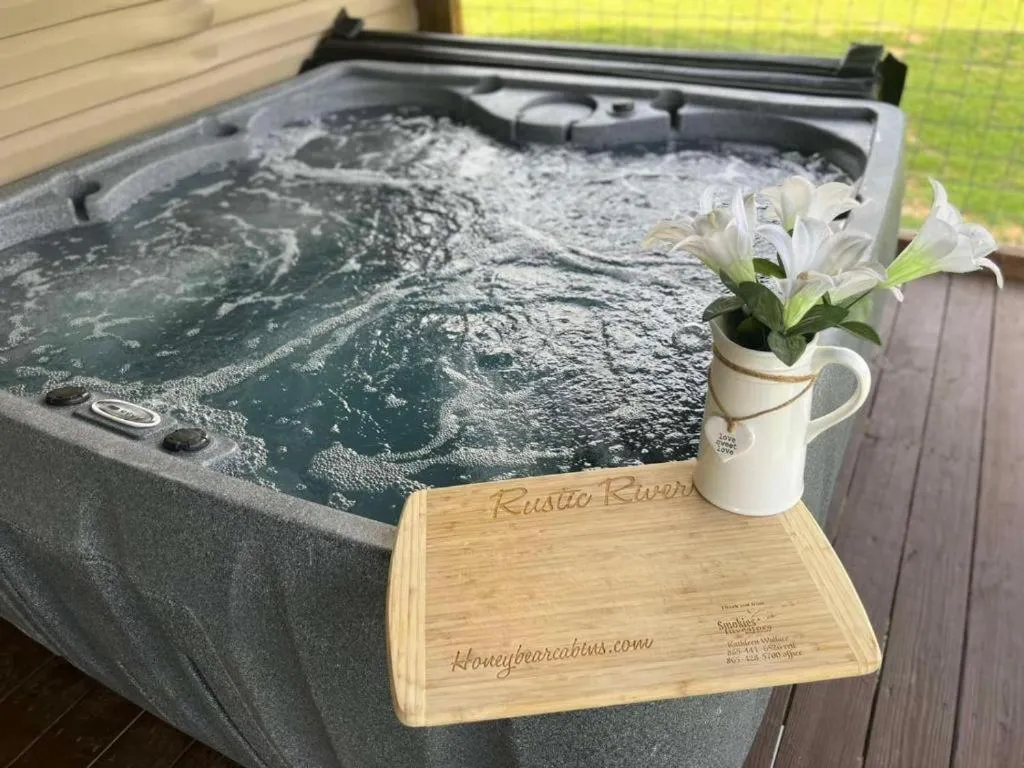 Hot Tub in Rustic River Lodge by HoneyBearCabins 7BR 6BA sleeps 21