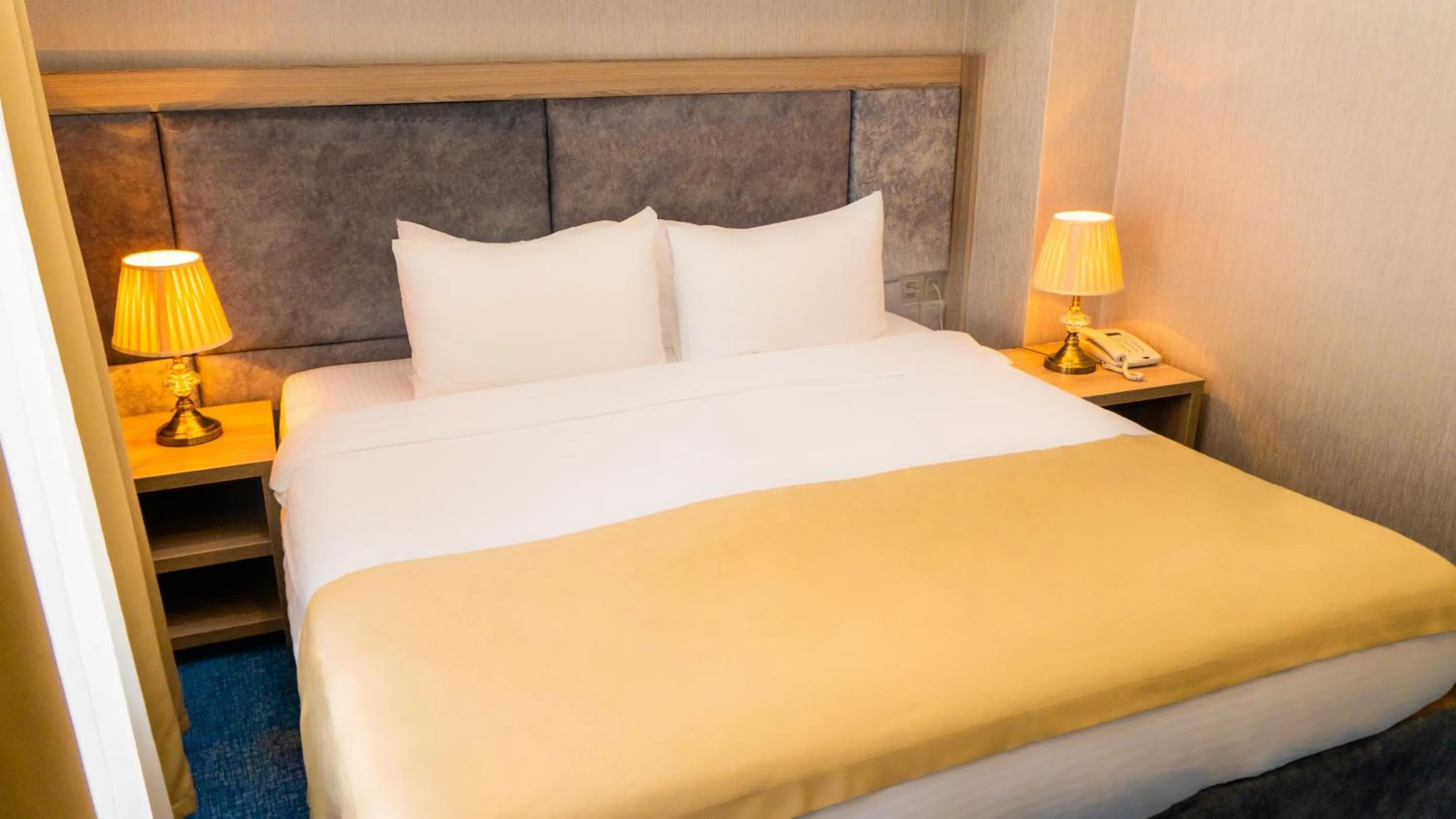 Bed in Grand Midway Hotel