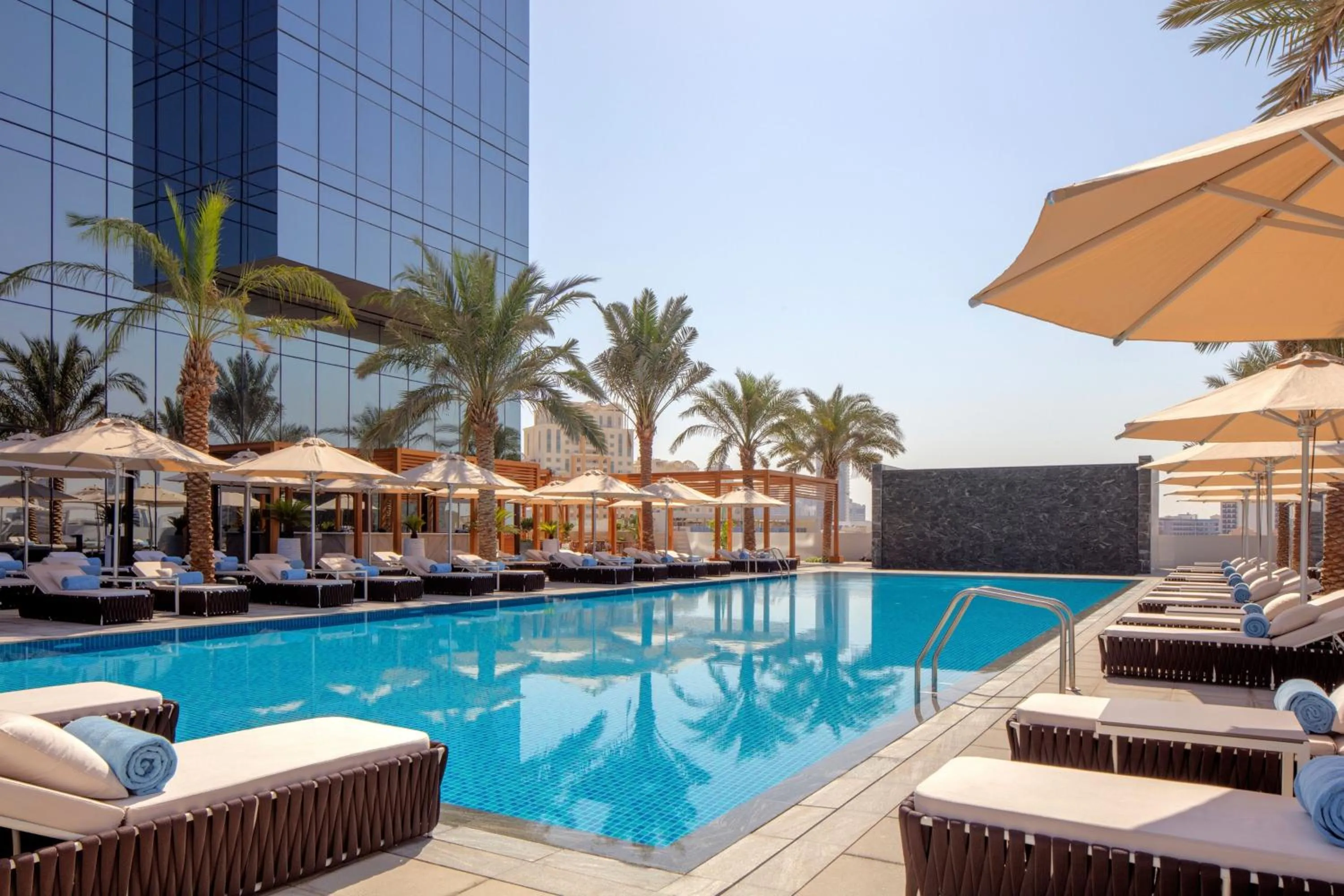 Swimming pool in The First Collection Dubai Jumeirah Village Circle, a Tribute Portfolio Hotel