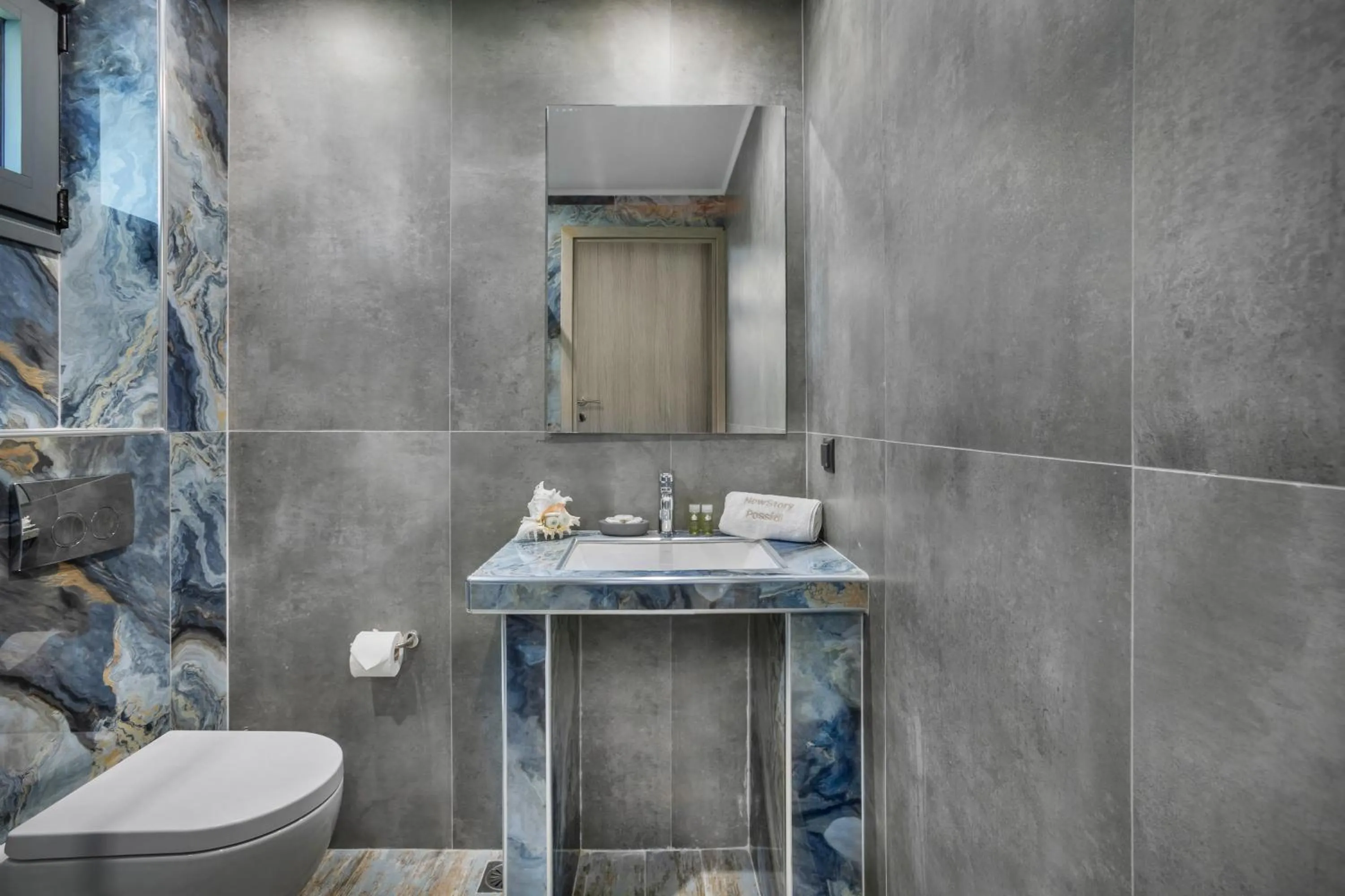Toilet in NewStory Suites Possidi