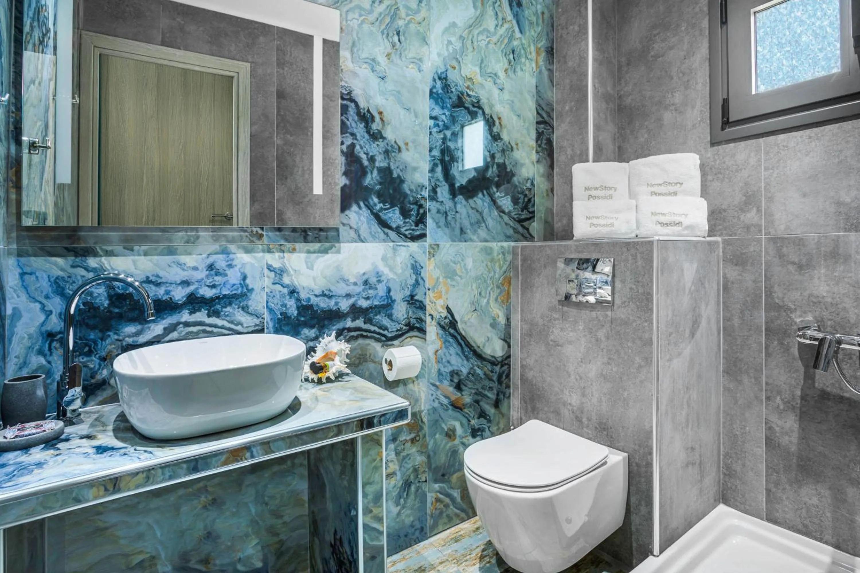 Toilet in NewStory Suites Possidi