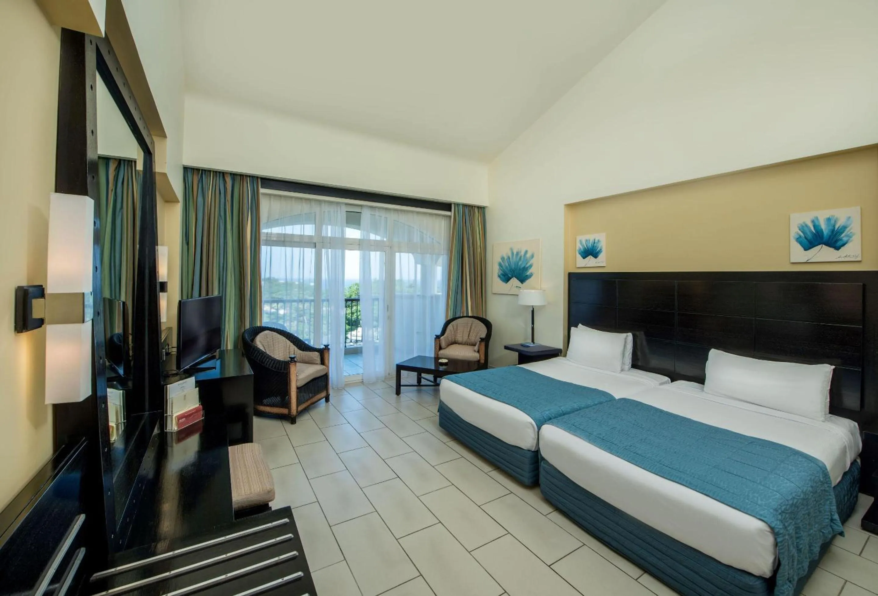 Photo of the whole room, Bed in Reef Oasis Blue Bay Resort & Spa