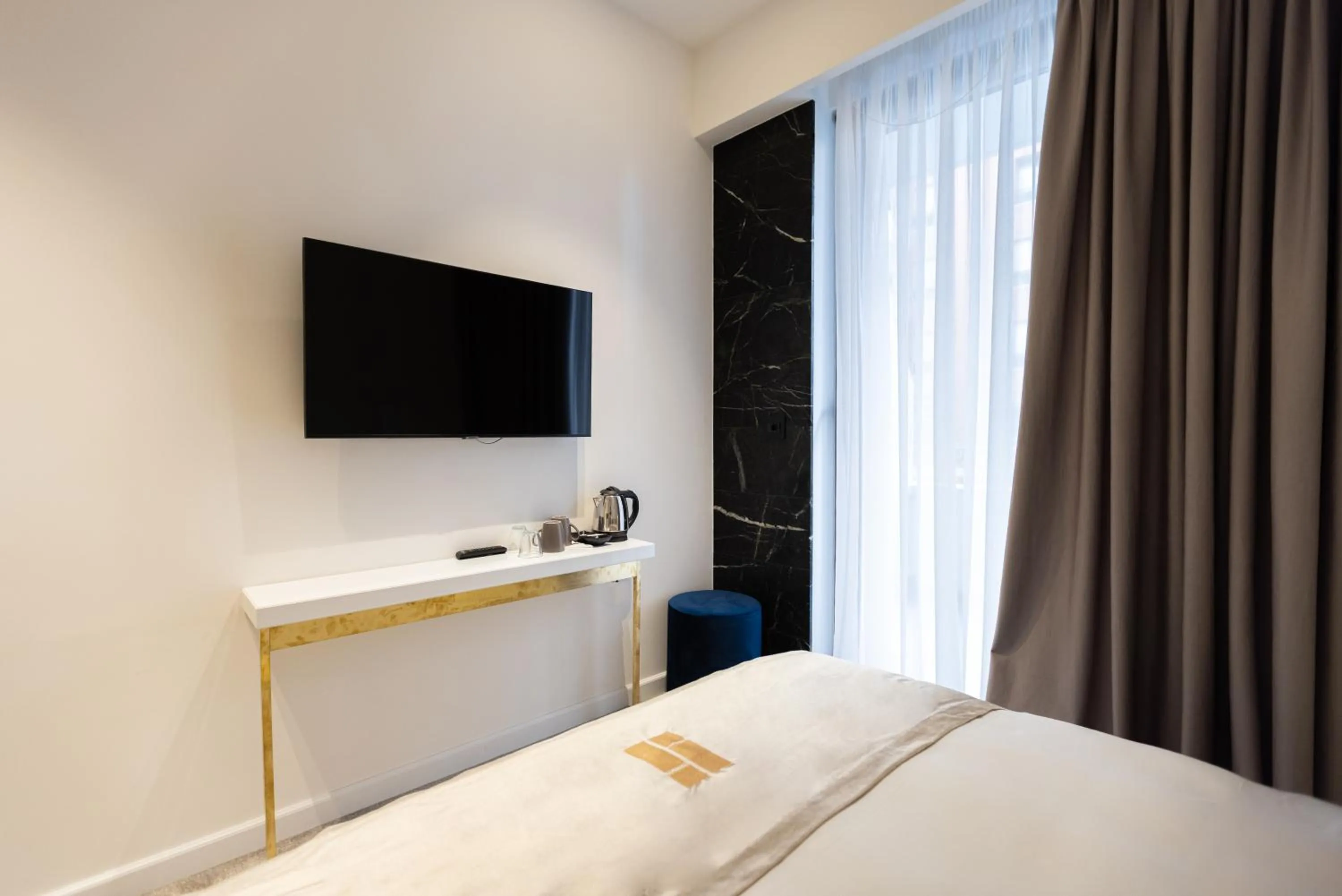 Communal lounge/ TV room, Bed in Habitat Hotel Tirana