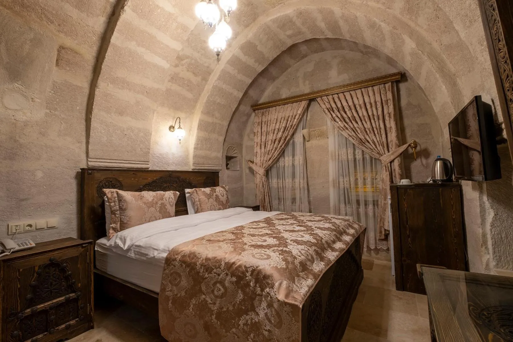 Bed in Underground Cave Suites Hotel
