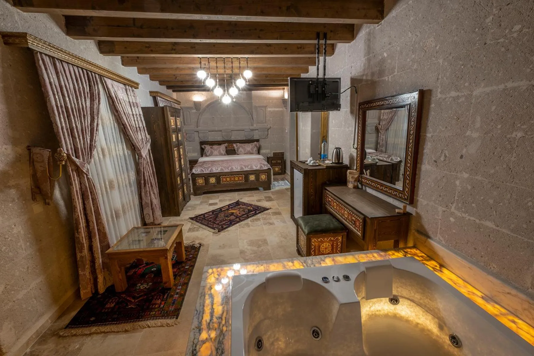 Bed in Underground Cave Suites Hotel