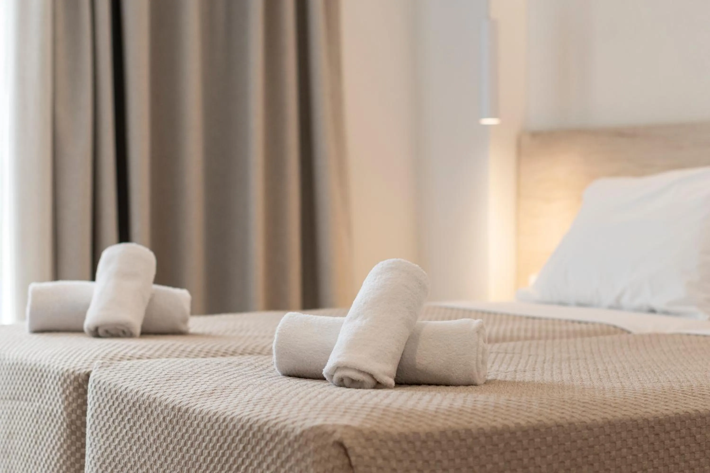 Bed in Mythos Suites Hotel