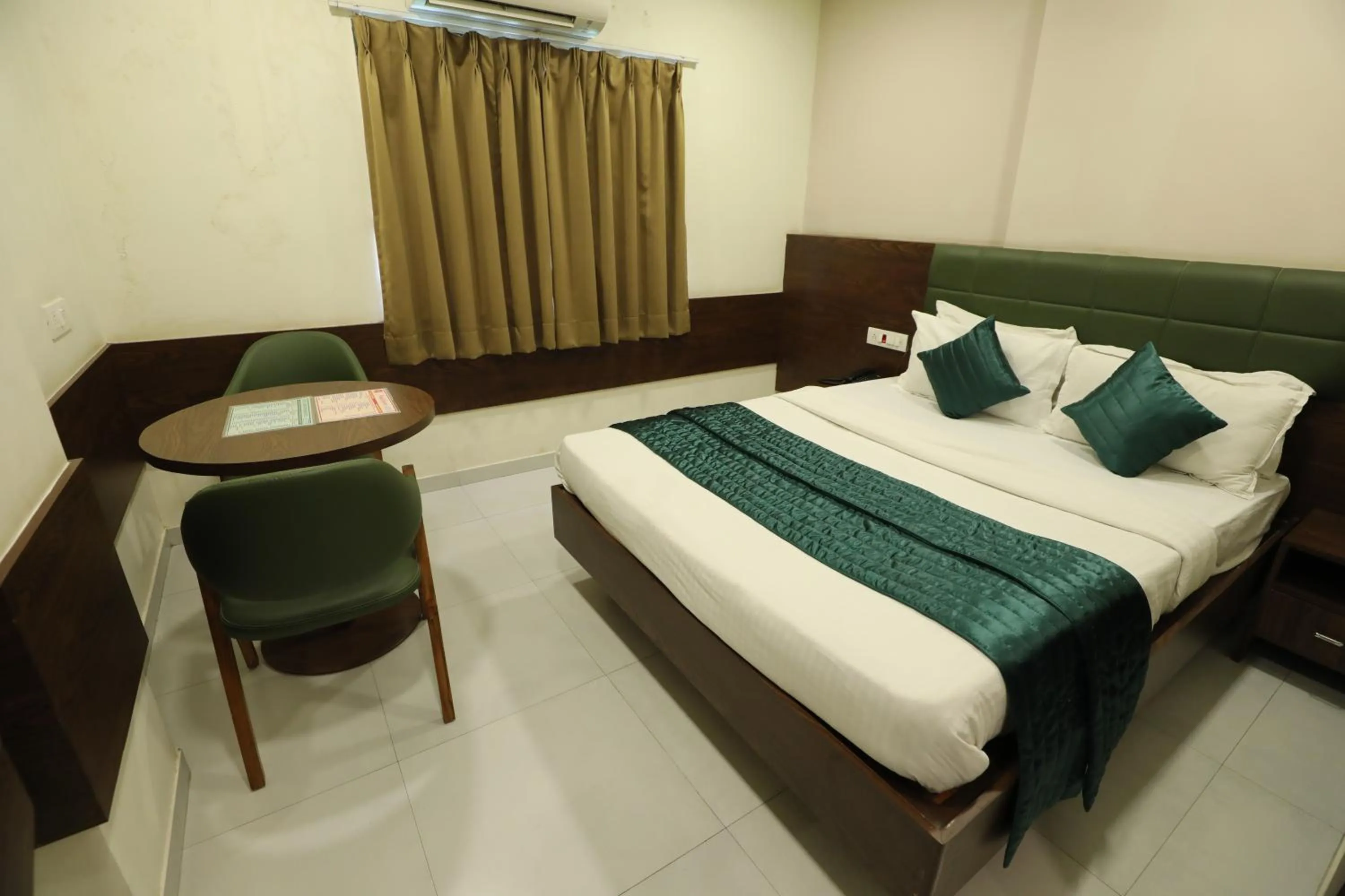 Bed in Greenotel Rooms Hazira, Surat