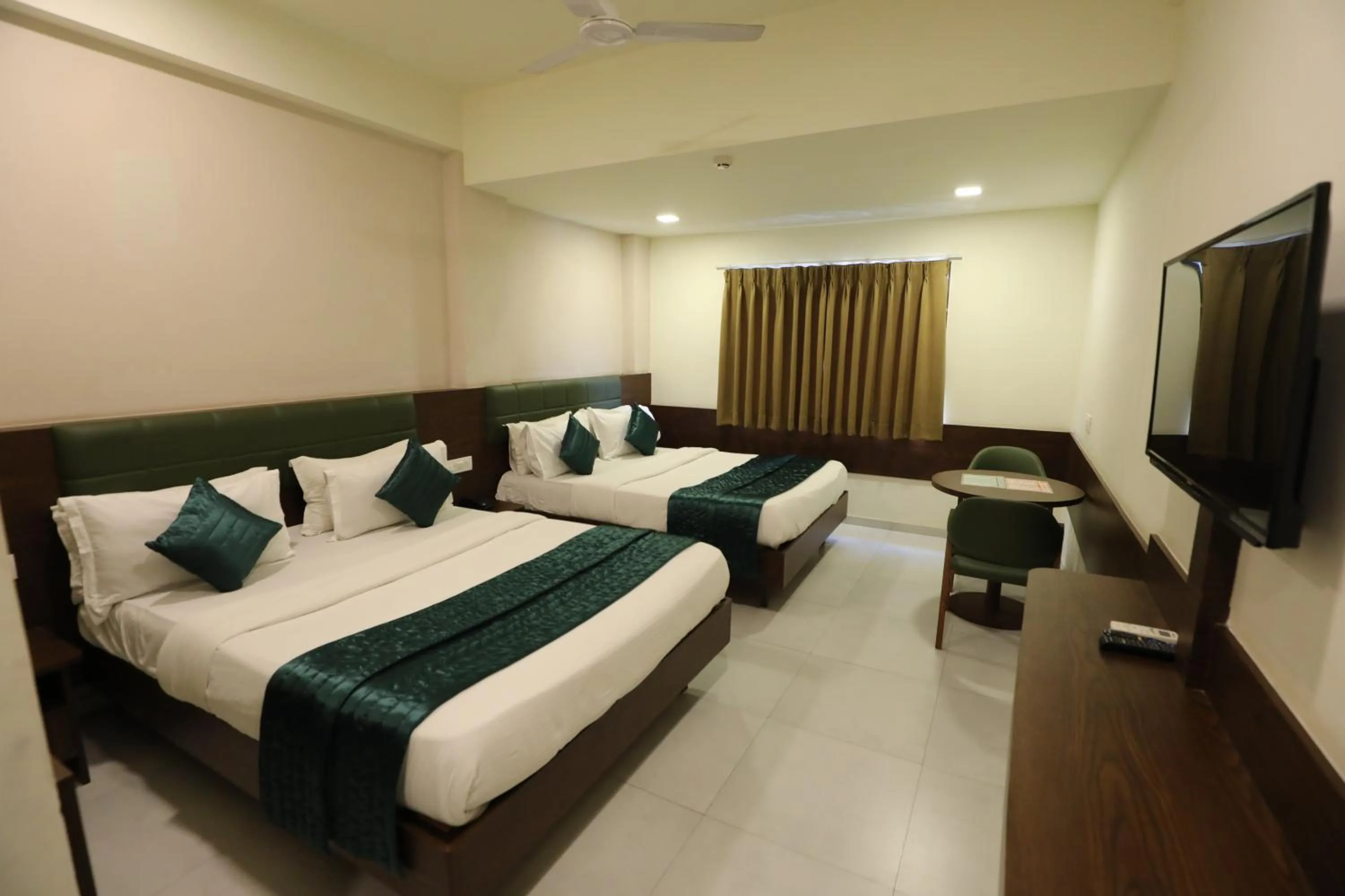 Bed in Greenotel Rooms Hazira, Surat