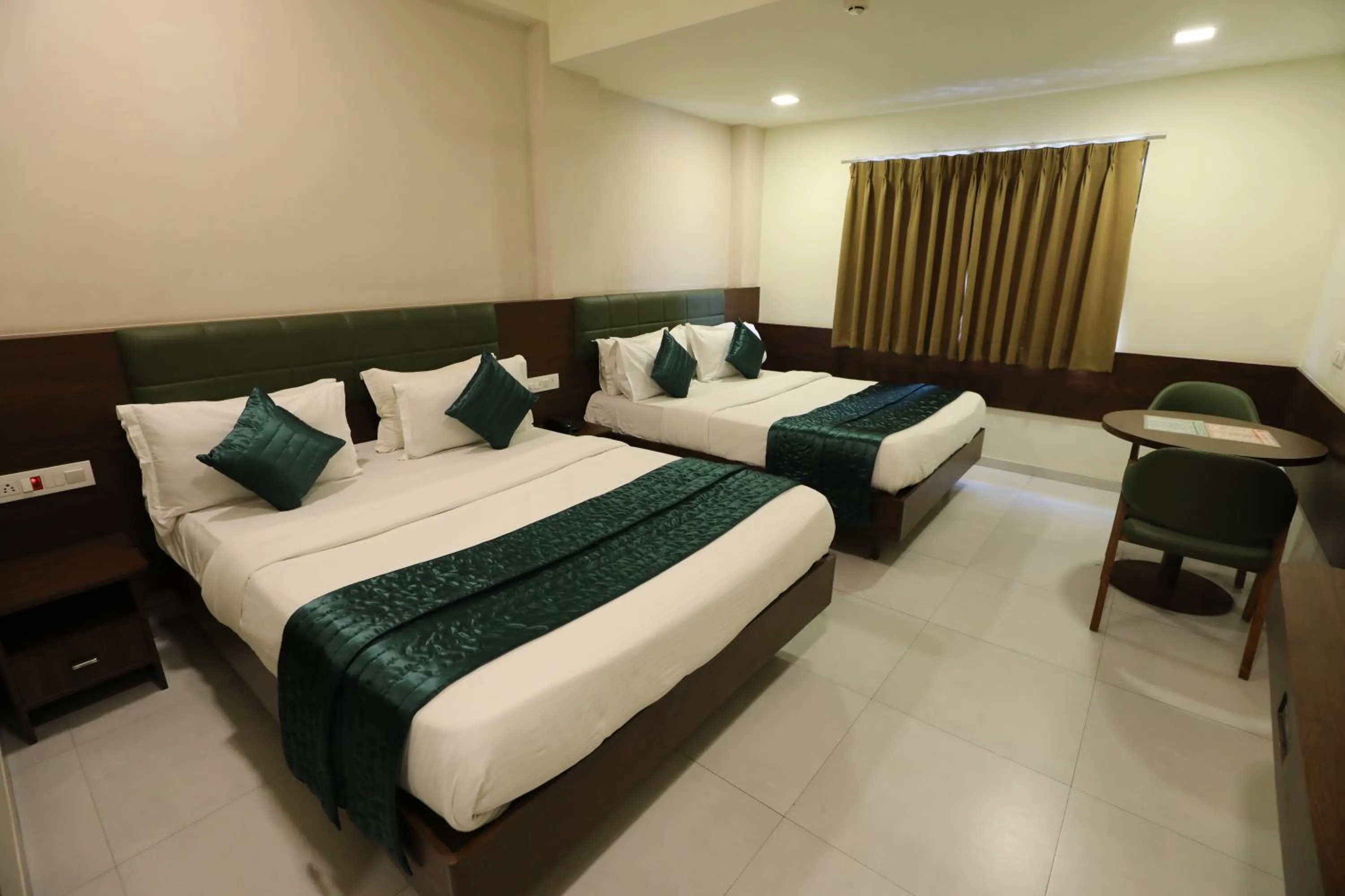 Bed in Greenotel Rooms Hazira, Surat