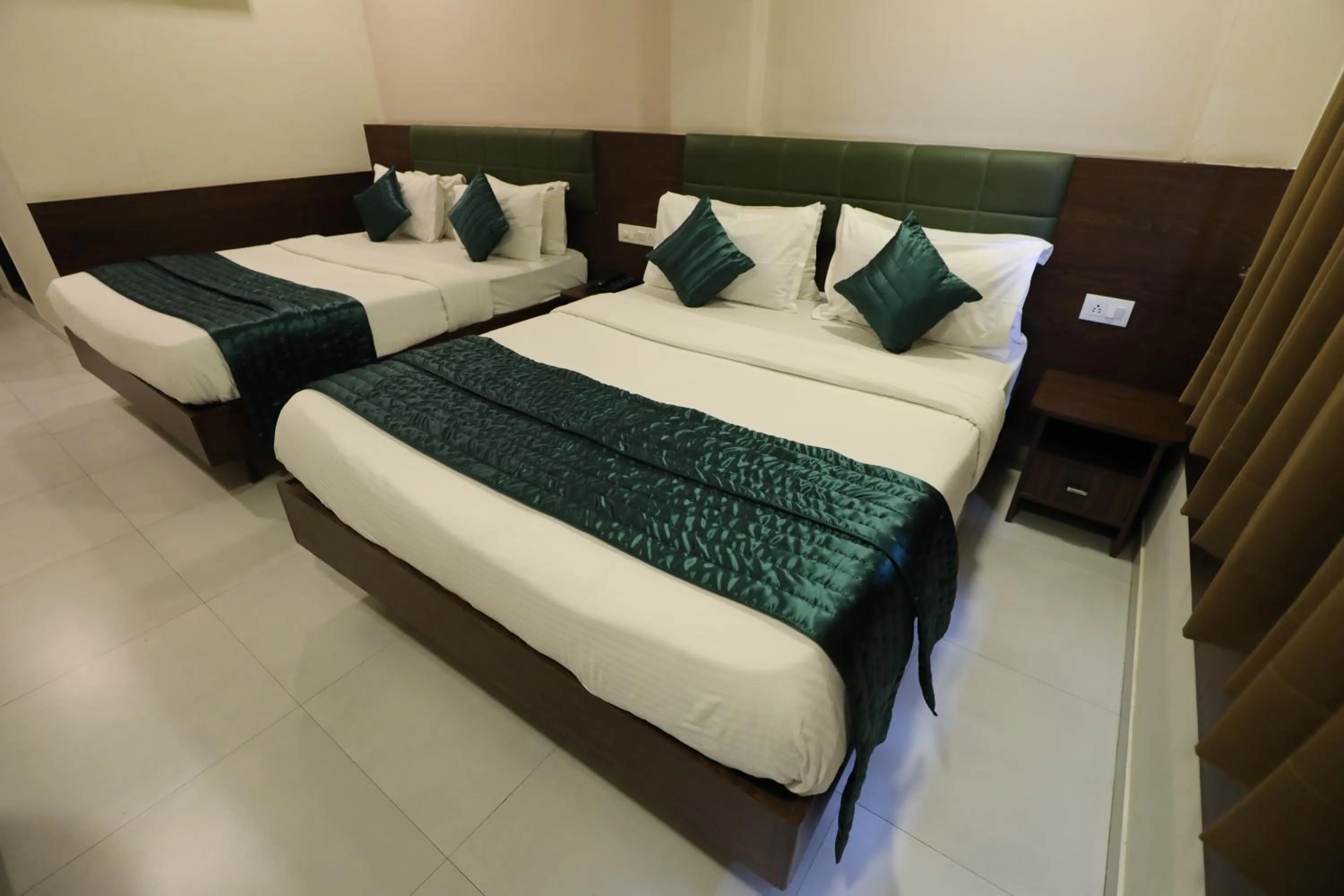 Bed in Greenotel Rooms Hazira, Surat