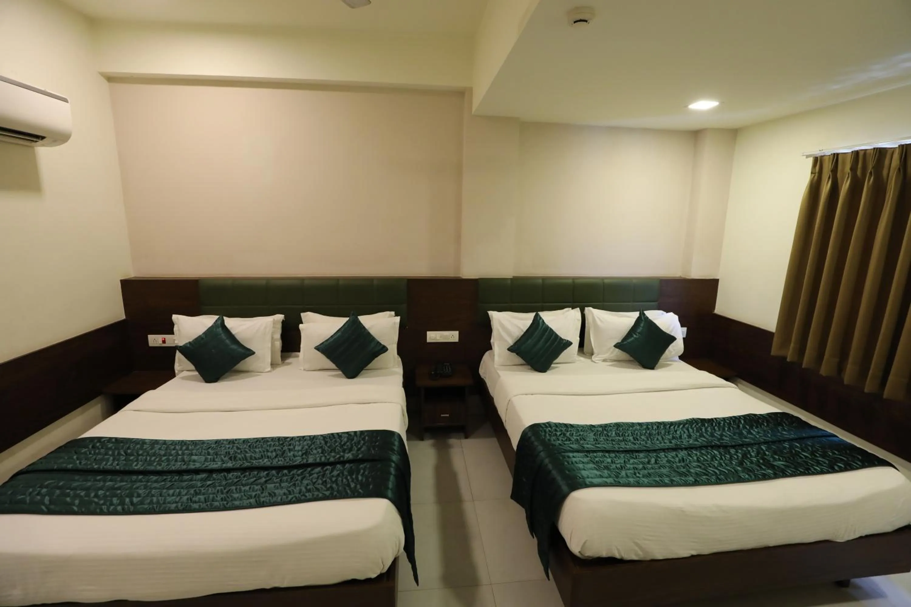 Bed in Greenotel Rooms Hazira, Surat